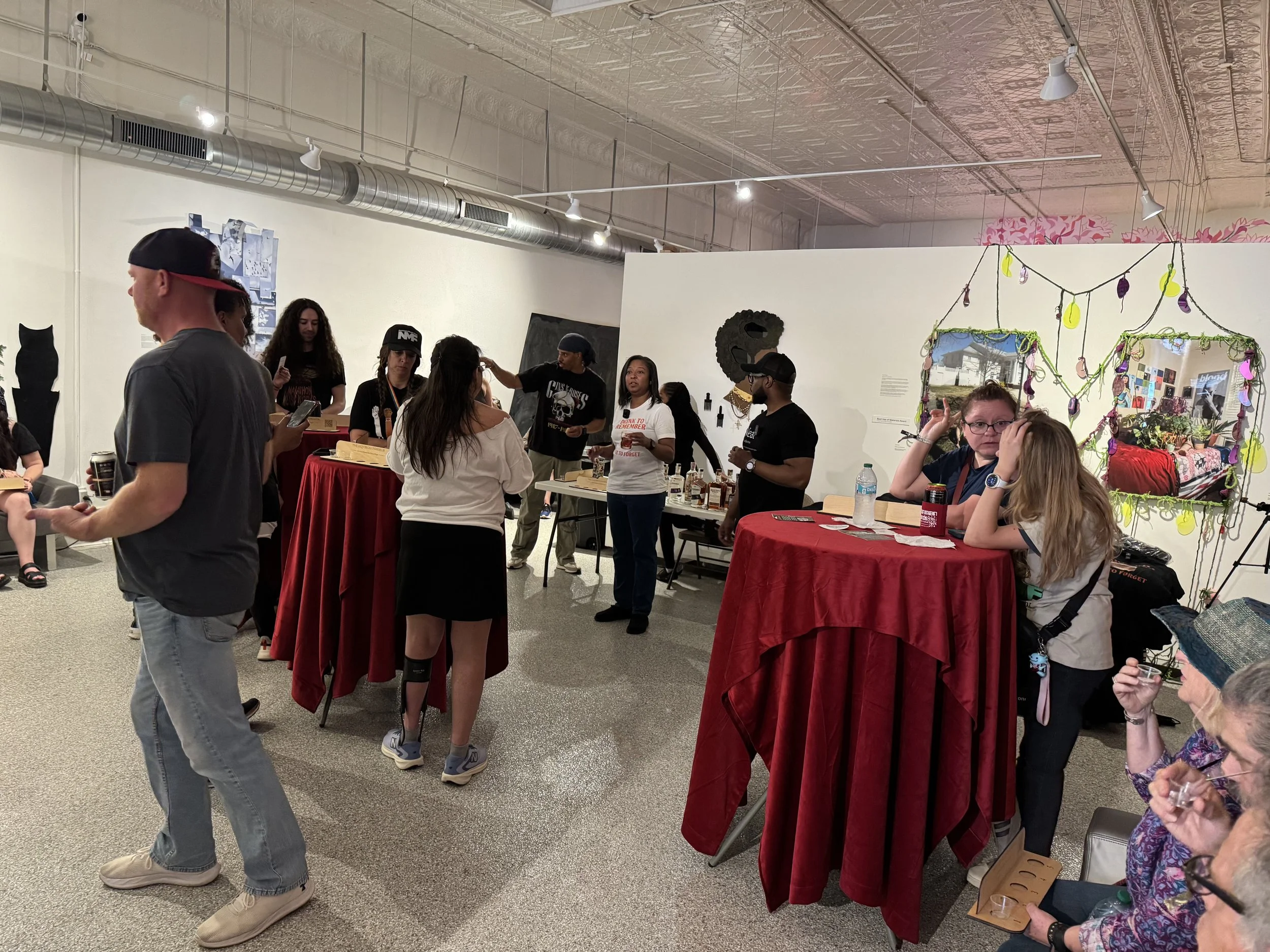 Several guests and VIP members mingle around small round tables