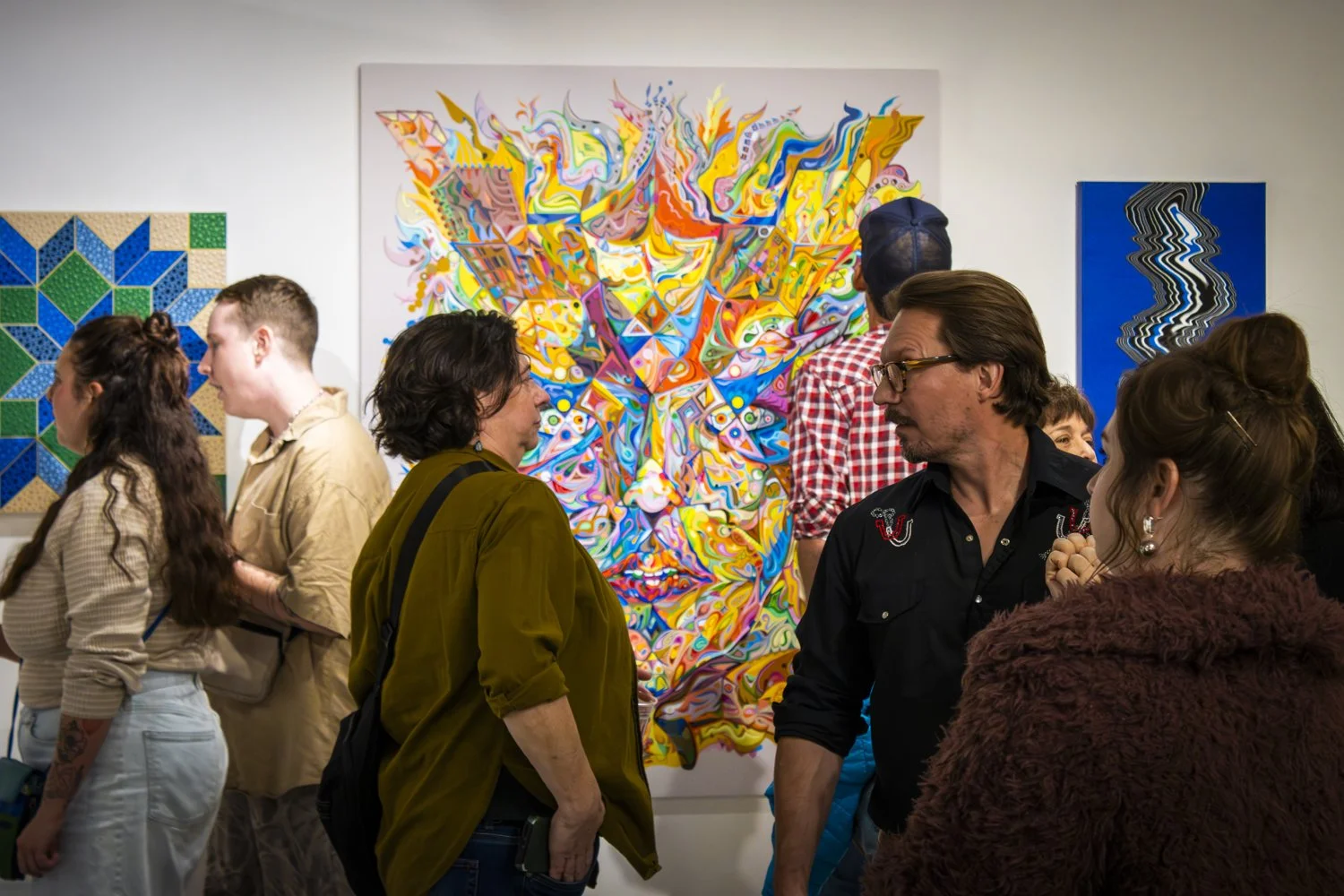 Artists and guests mingle together during the November Art Walk opening of Art Soup 2.0 at Uncanny Art Hosue
