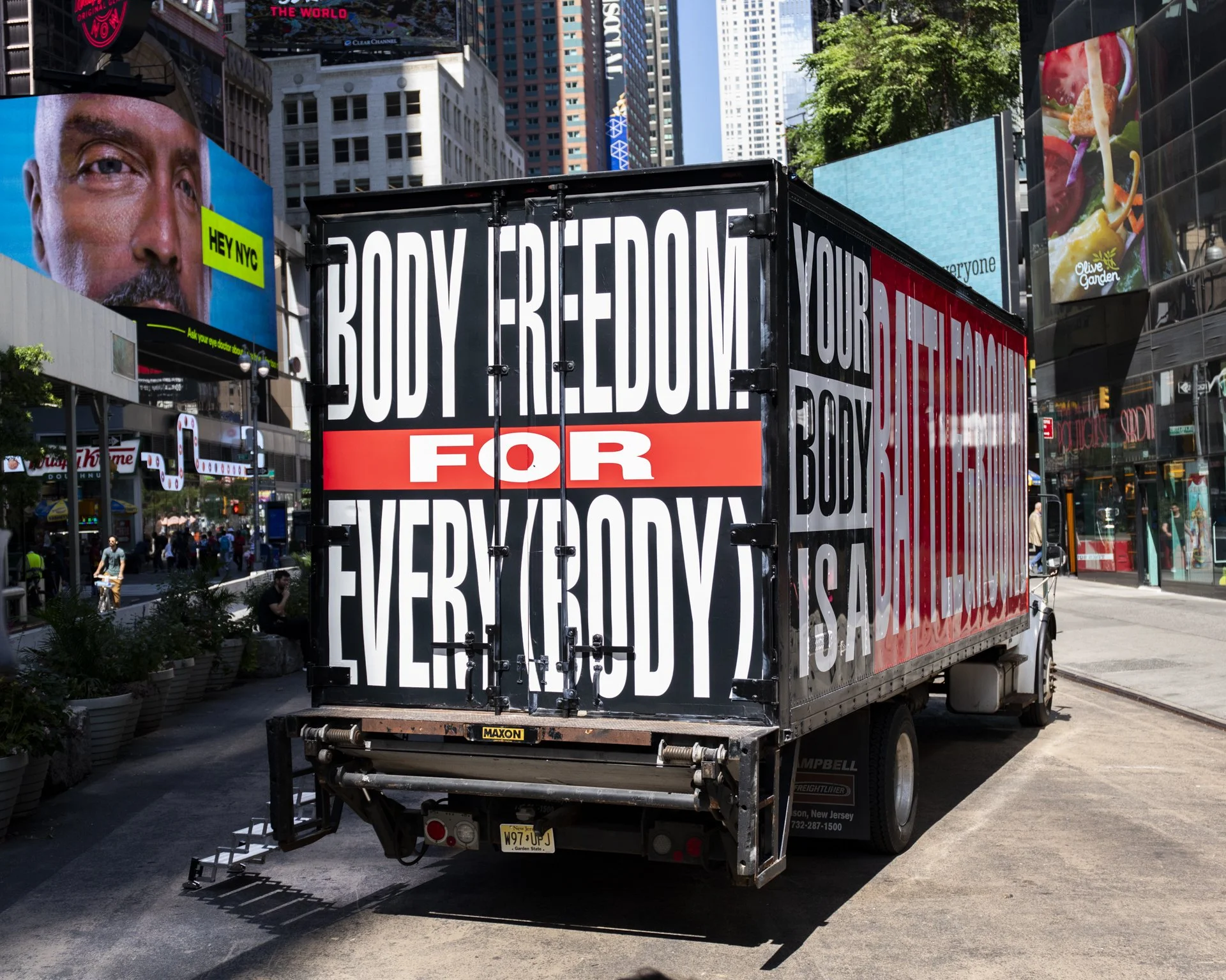 The artist reworks her iconic Untitled (Your Body is a Battleground) imagery on a truck to advocate bodily autonomy. Bold text on the vehicle calls for healthcare, gender, civil, housing, and human rights.