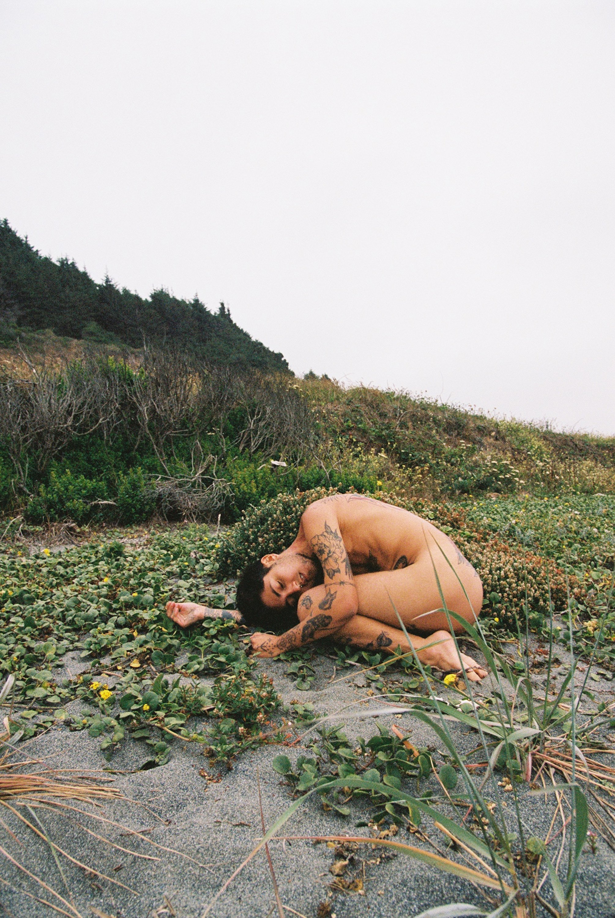 Homeland Womb is a self-portrait on the Northern California coast near the Yurok and Karuk reservations. The artist curls into a fetal position on warm sand, cradled by the landscape.