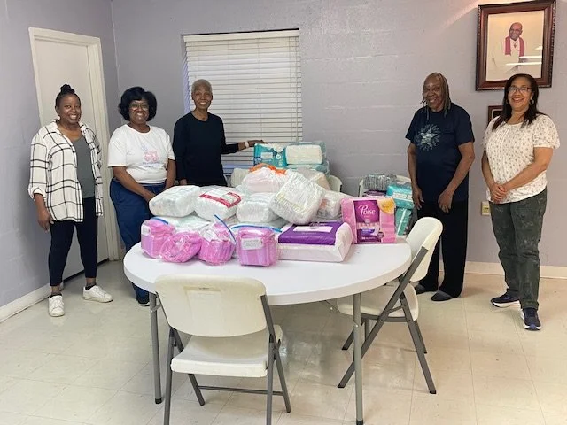 Stanley Community Church's Women of Faith Volunteers helping wrap diapers, they also donated diapers.