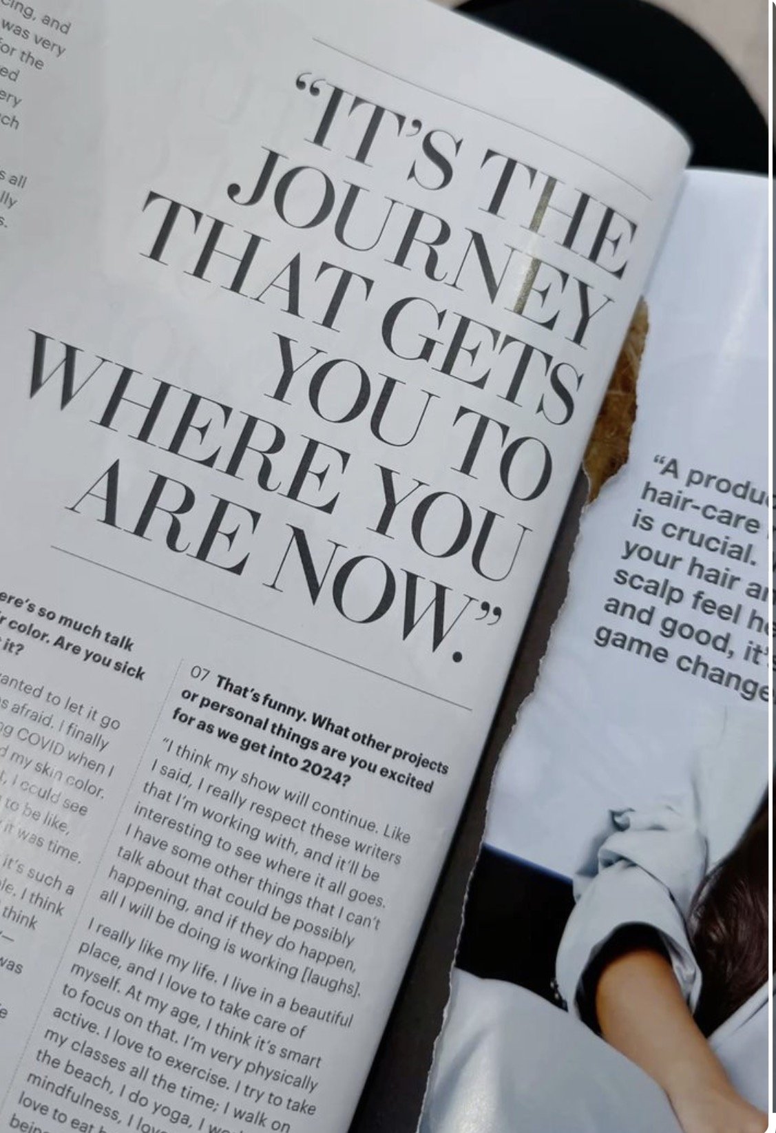 Open magazine page with a quote in large text saying, "It's the journey, not the destination, that gets you to where you are now." The page includes smaller text, articles, and an image of a woman in a casual gray shirt.