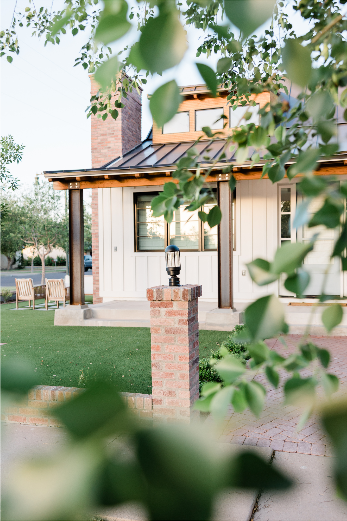 Artificial turf lawn in the front yard of a home with a covered porch.