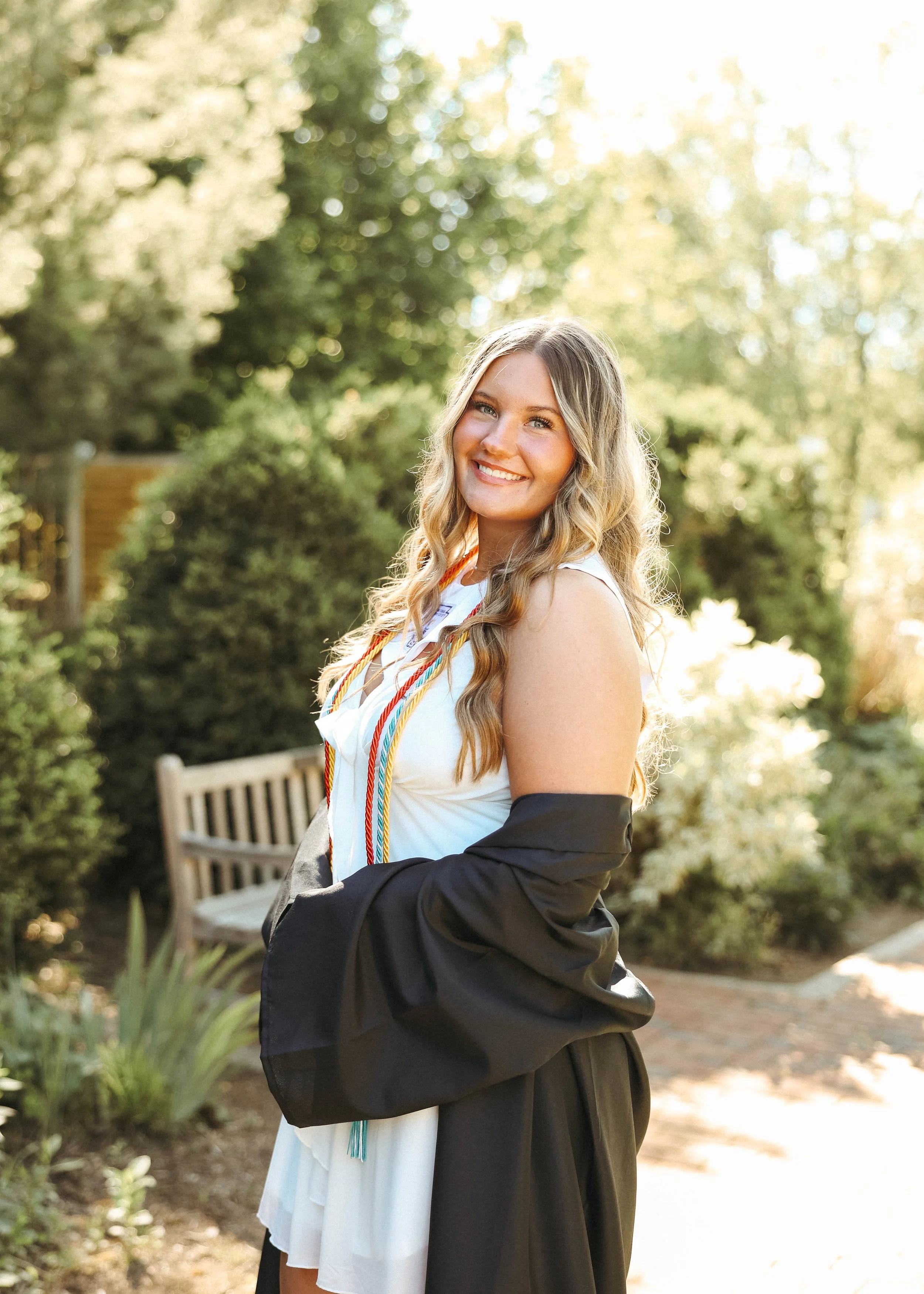 Senior pictures at the UK Arboretum in Lexington, KY, featuring a senior girl posing among flowers and greenery.