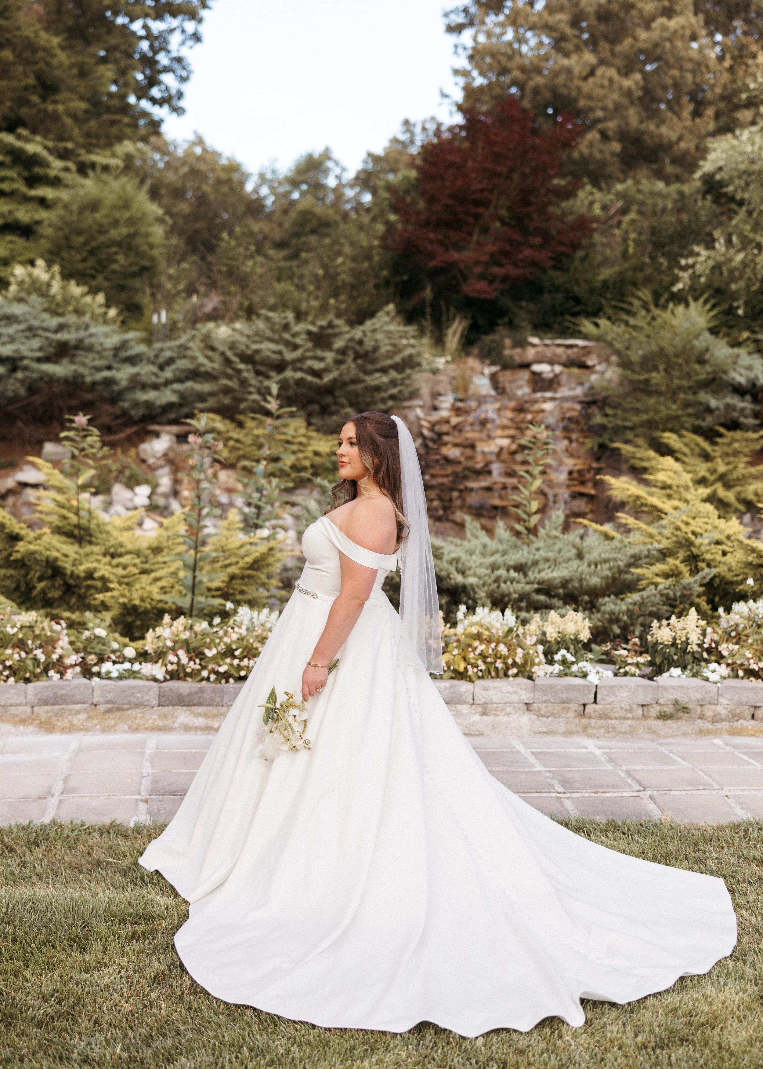 Bride standing in a courtyard taking her bridal portraits