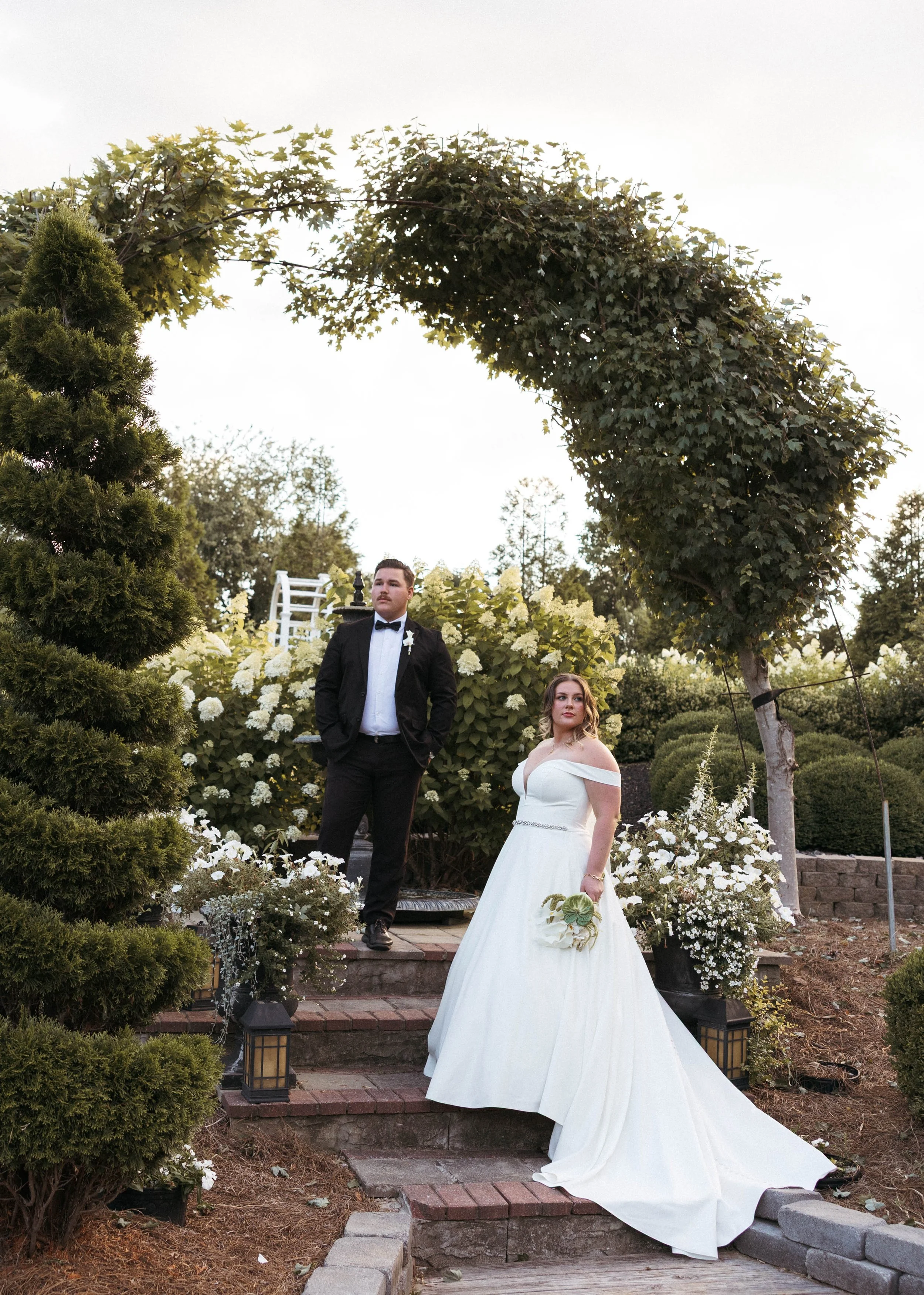 Kentucky bride and groom looking into the distance while taking bride and groom portraits after their ceremony