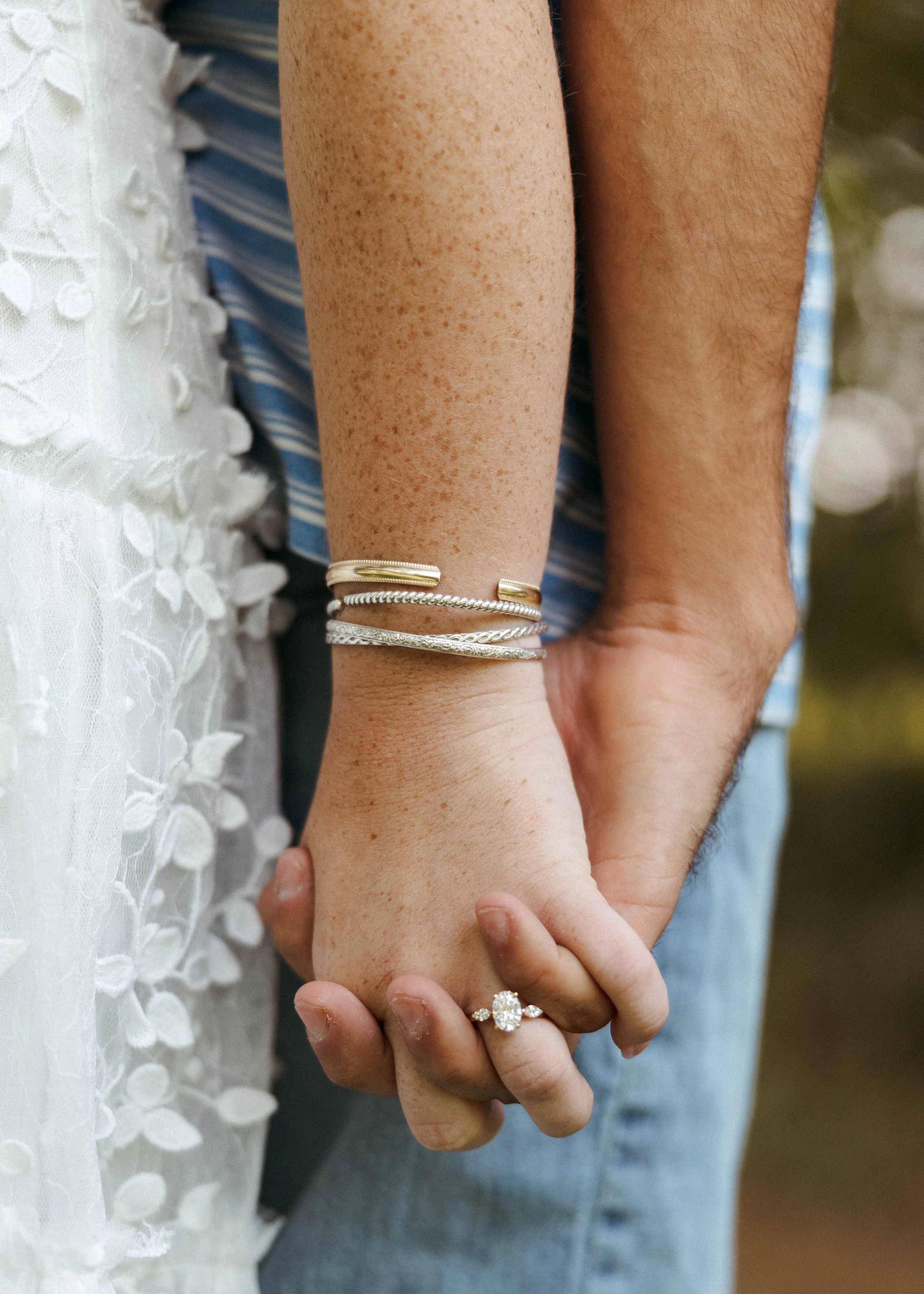 Newly engaged couple holding hands to show off bride's ring