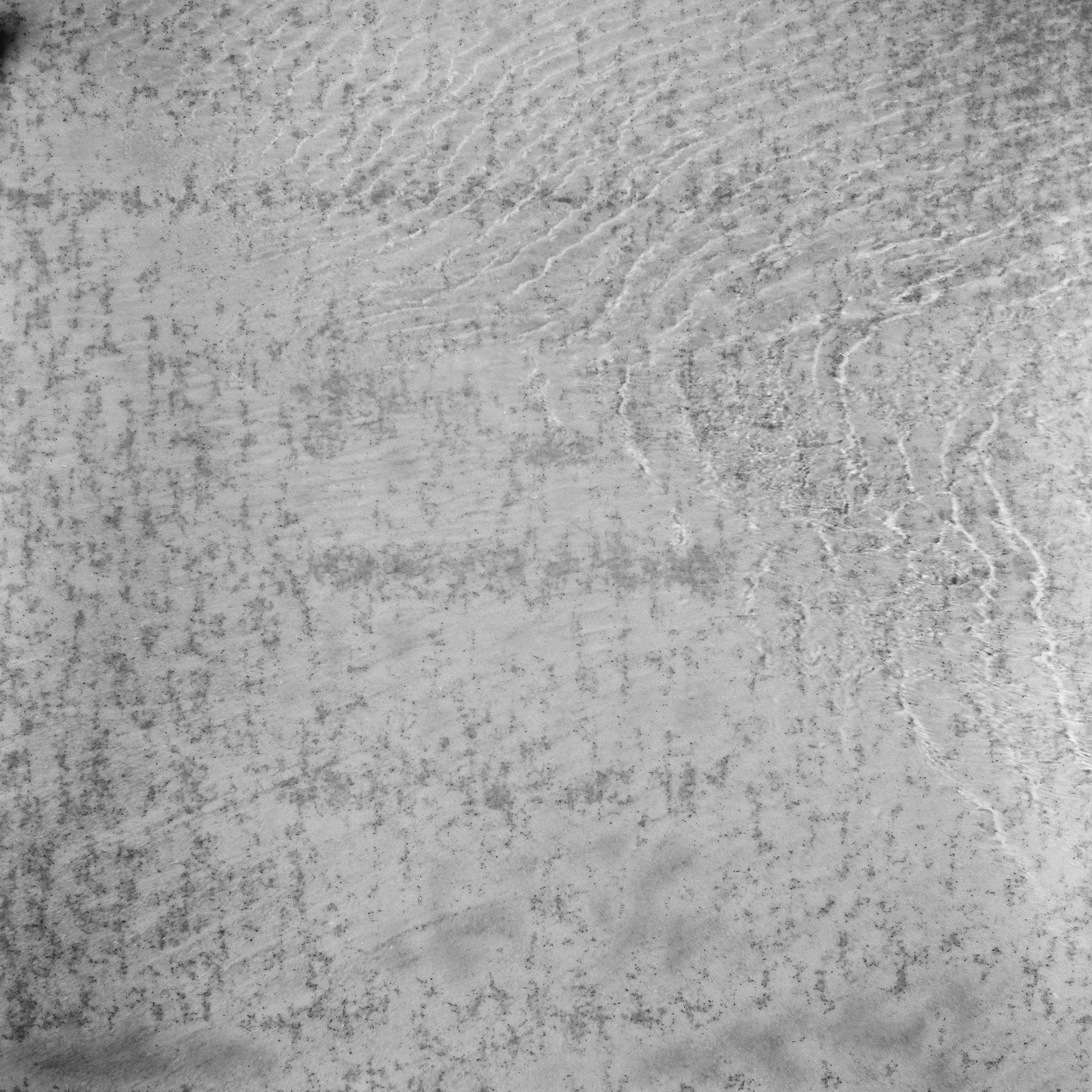 Close-up of a concrete or plaster wall surface with visible texture and patterns.