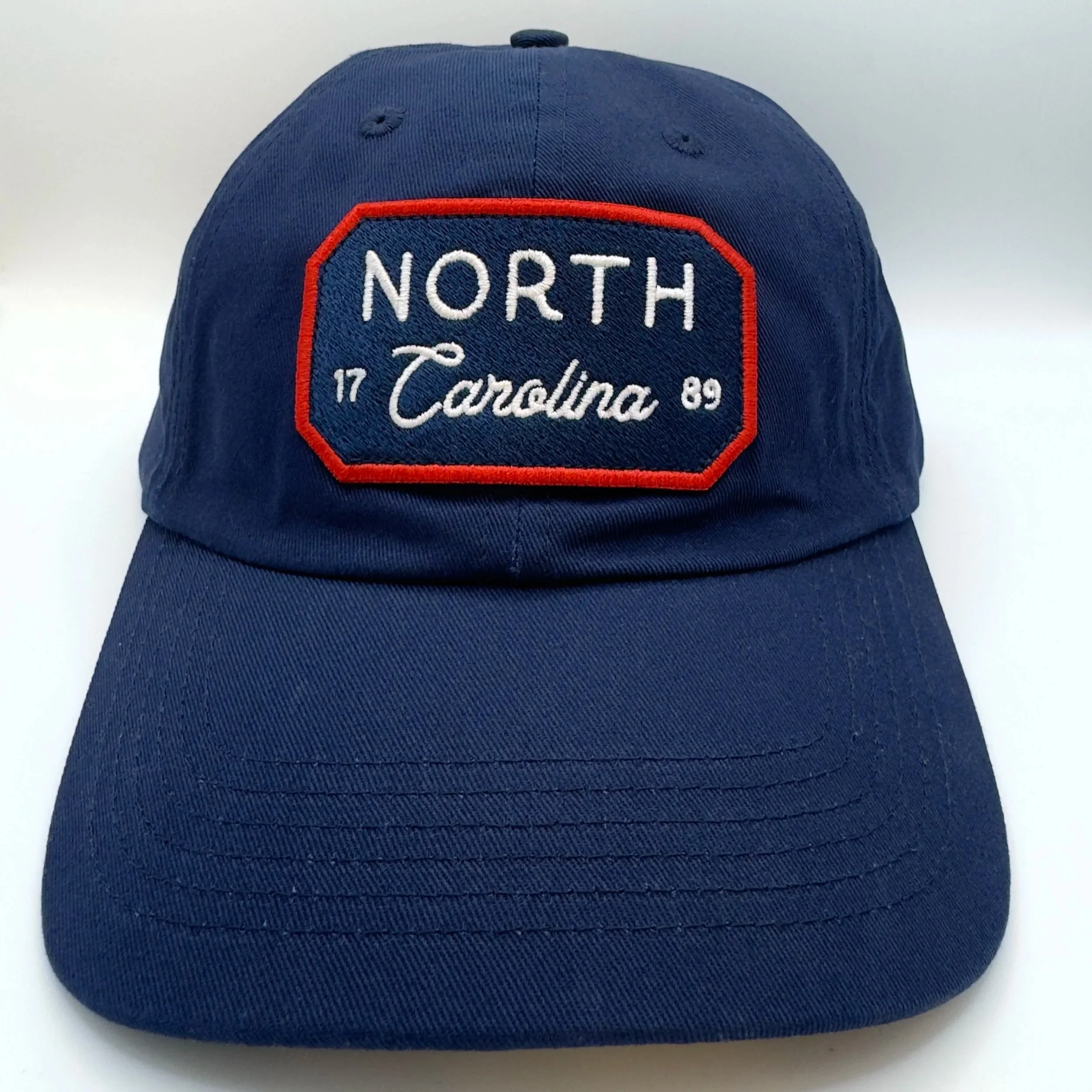 Front view of navy North Carolina USA 1789 dad hat with navy, white, and red embroidered patch