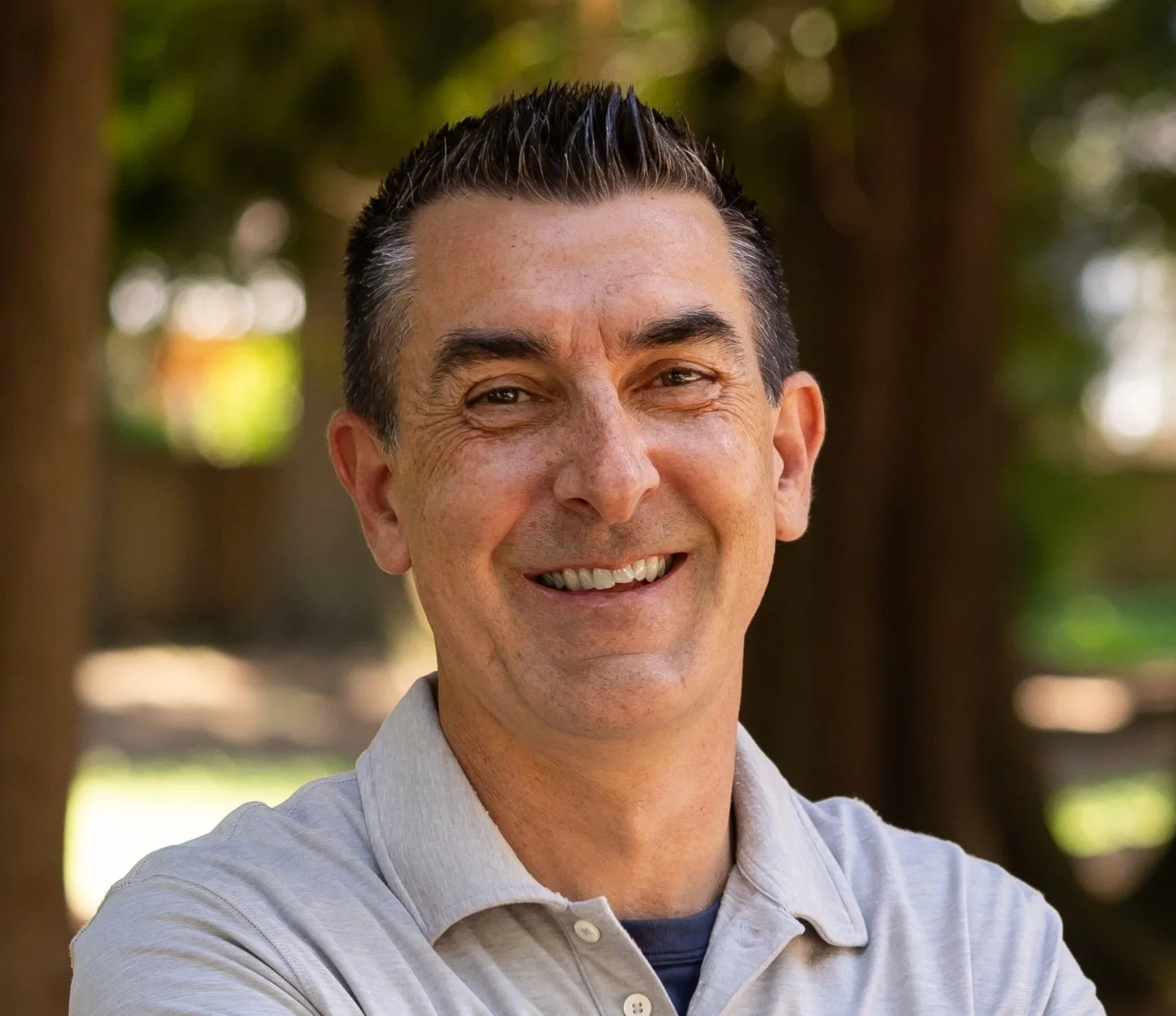 Man with glasses and beard in a suit and white shirt