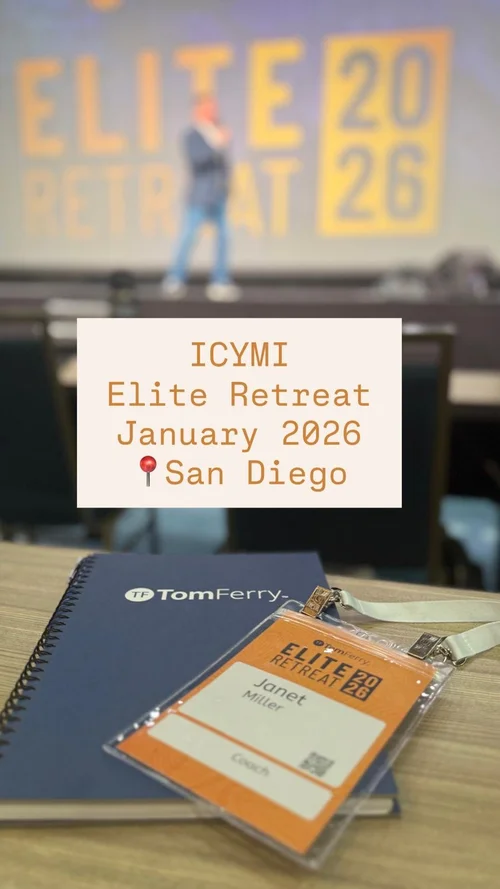 Conference badge reading 'ICYMI Elite Retreat January 2026 San Diego' placed on a wooden table with a black notebook and a white lanyard. In the background, a presenter stands on stage with a blurred large screen displaying 'ELITE RETREAT 2026'.