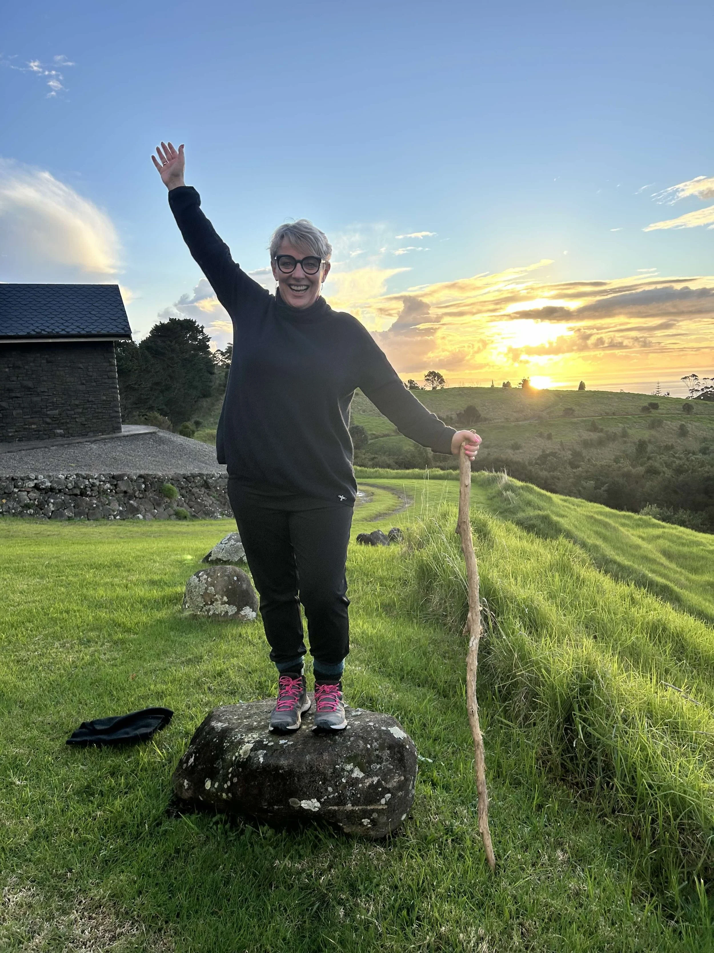 Lisa with stick near chapel with arm up.jpg