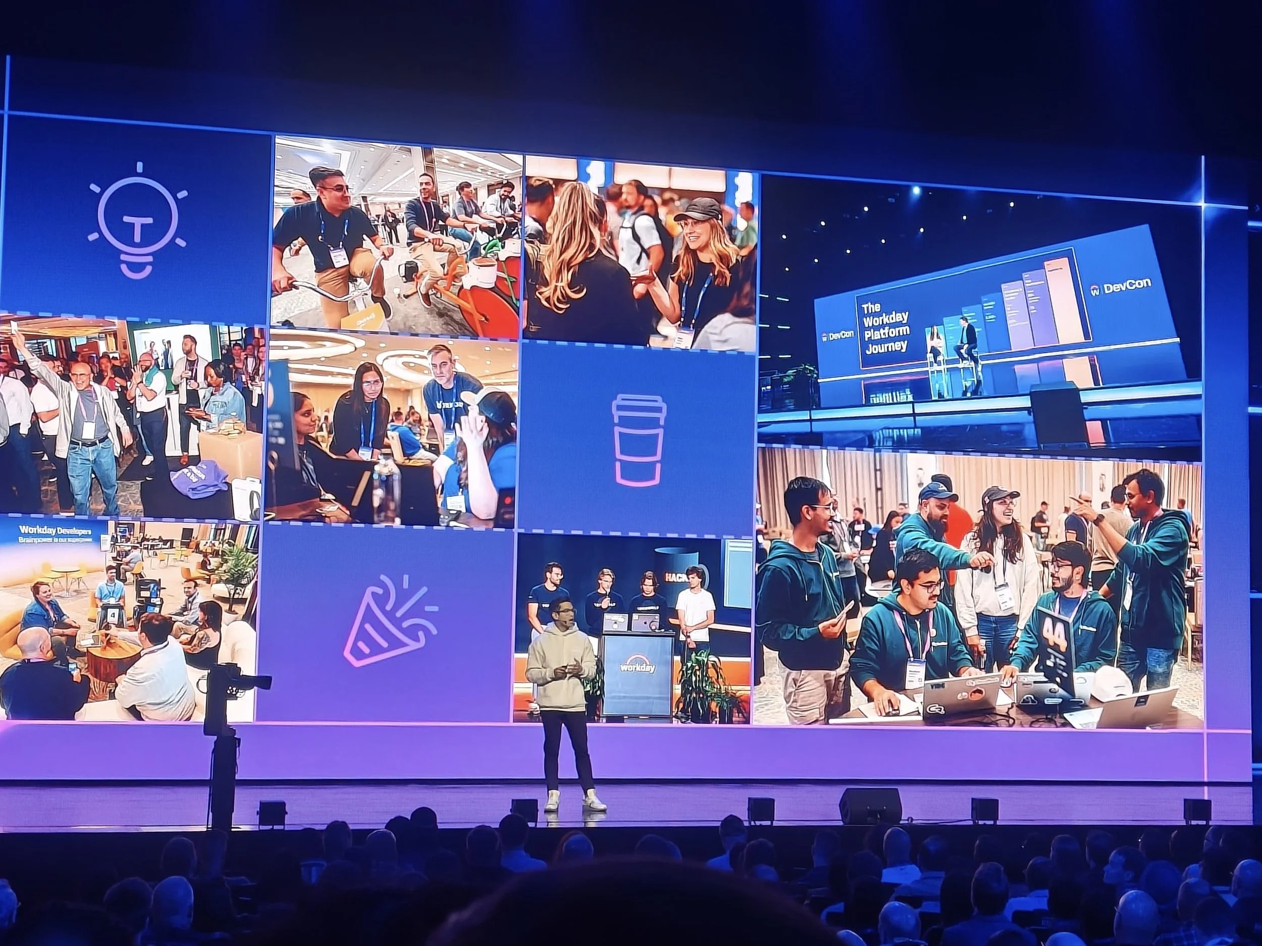 Workday DevCon 2026 keynote stage with a large screen displaying a photo collage of developers networking, collaborating and building at the event