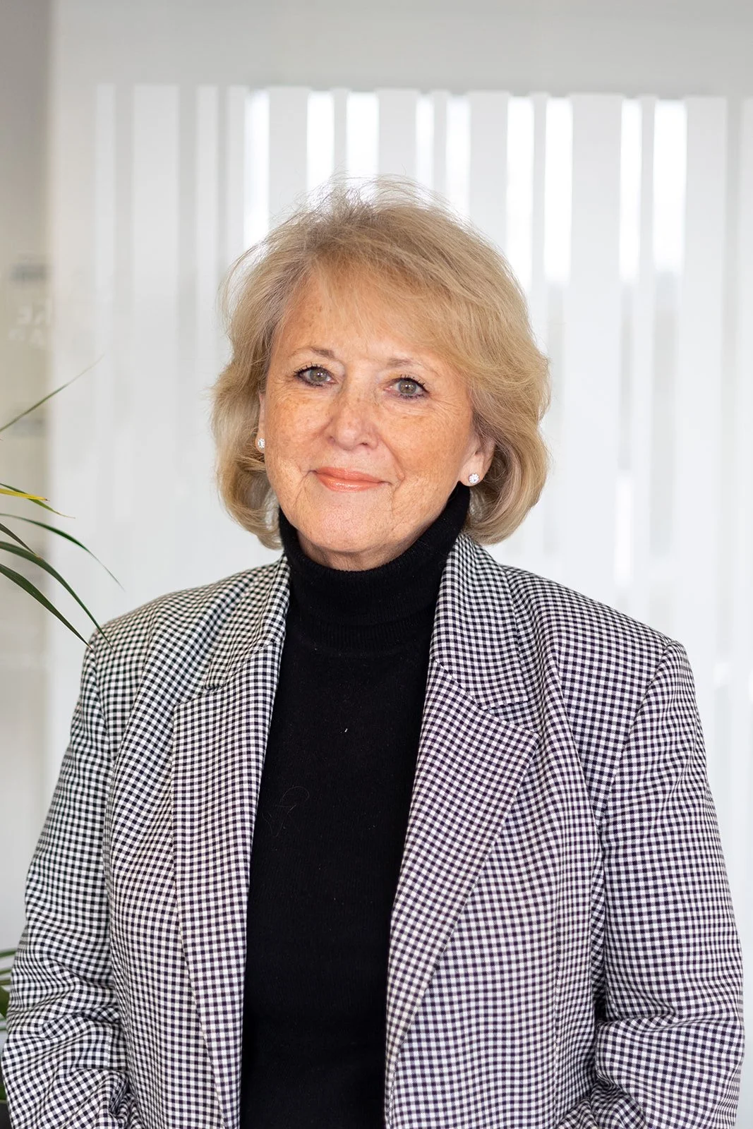 DIana Whittington in a suitjacket and roll neck top smiles