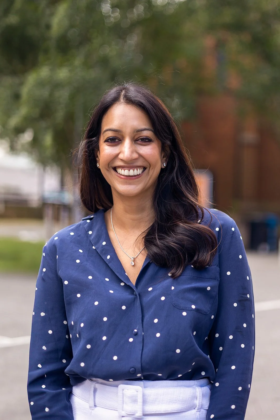 Dr Ruchika Gupta in a blue shirt and light trousers smiling