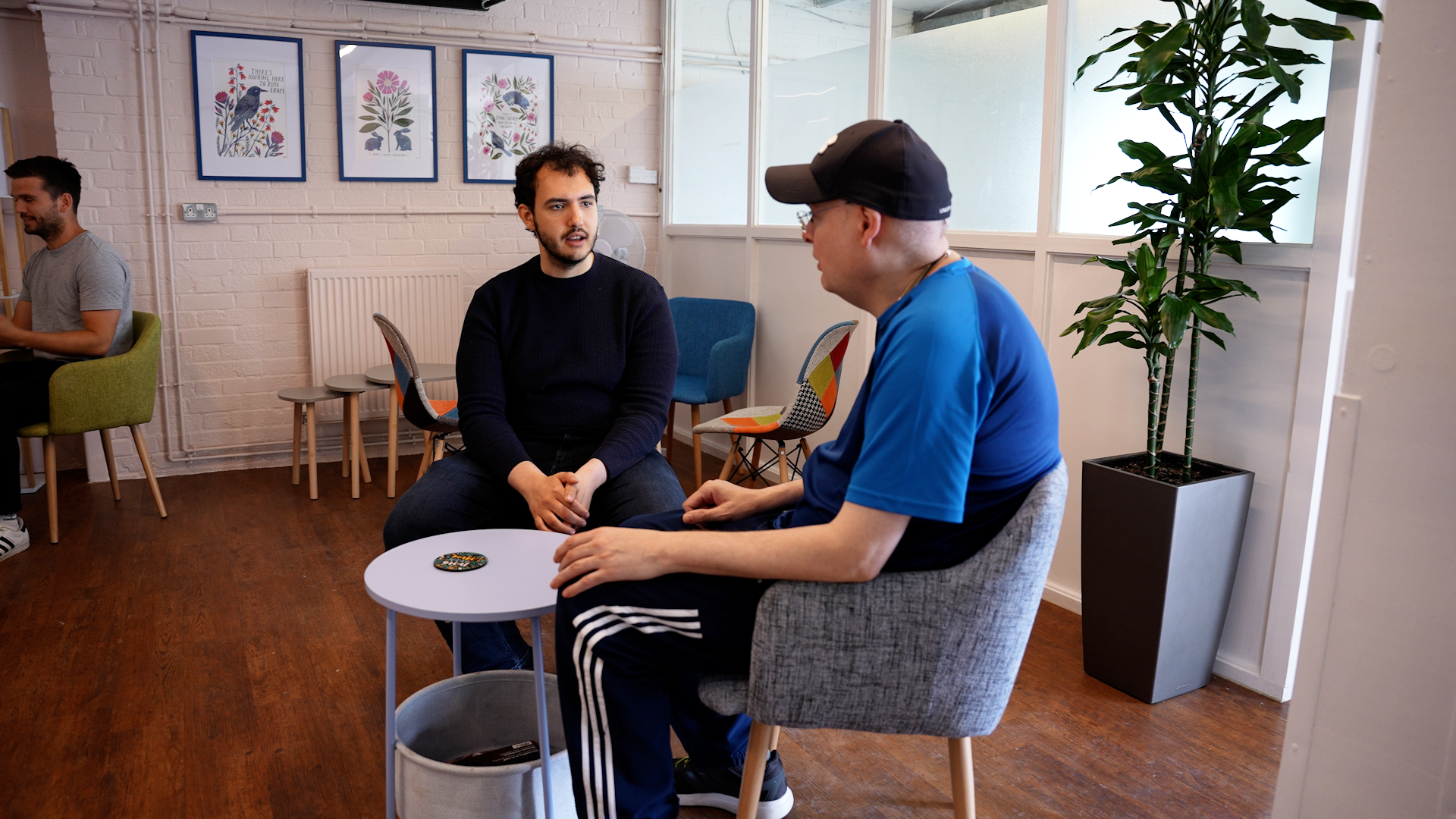 Photo from Oakleaf Enterprise, two men sitting, chatting at a table