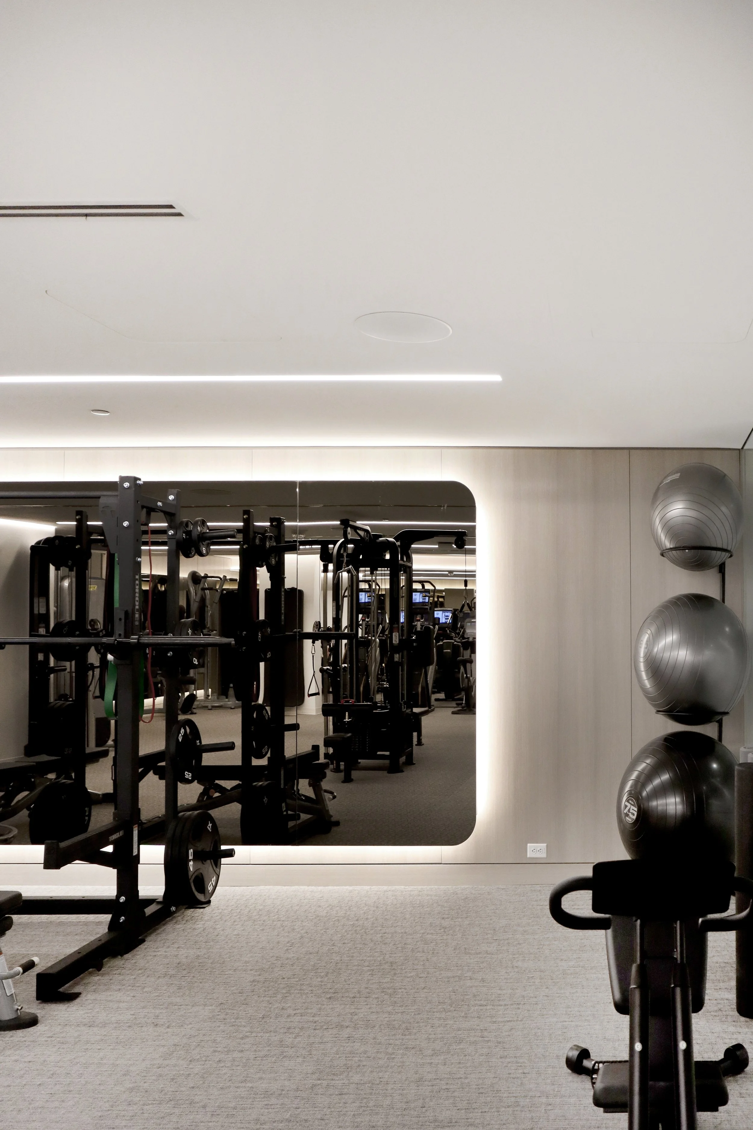 Backlit Gym Mirror with Curved Edges