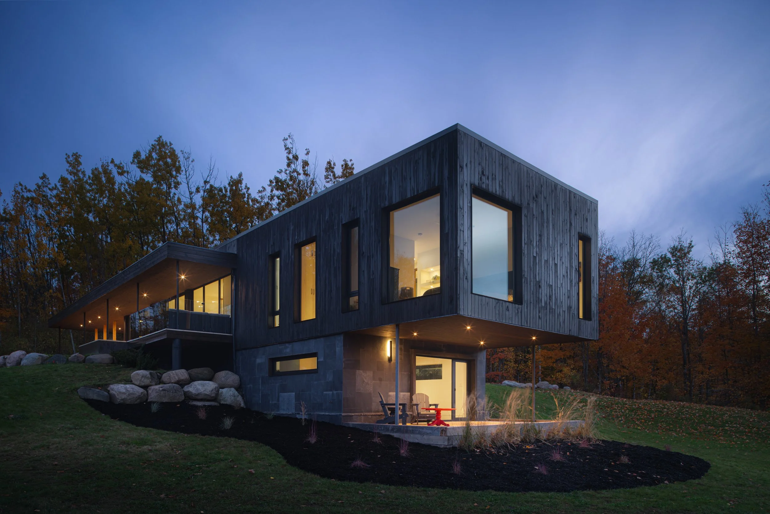 Exterior shot of cantilevered edge of modern house at dusk