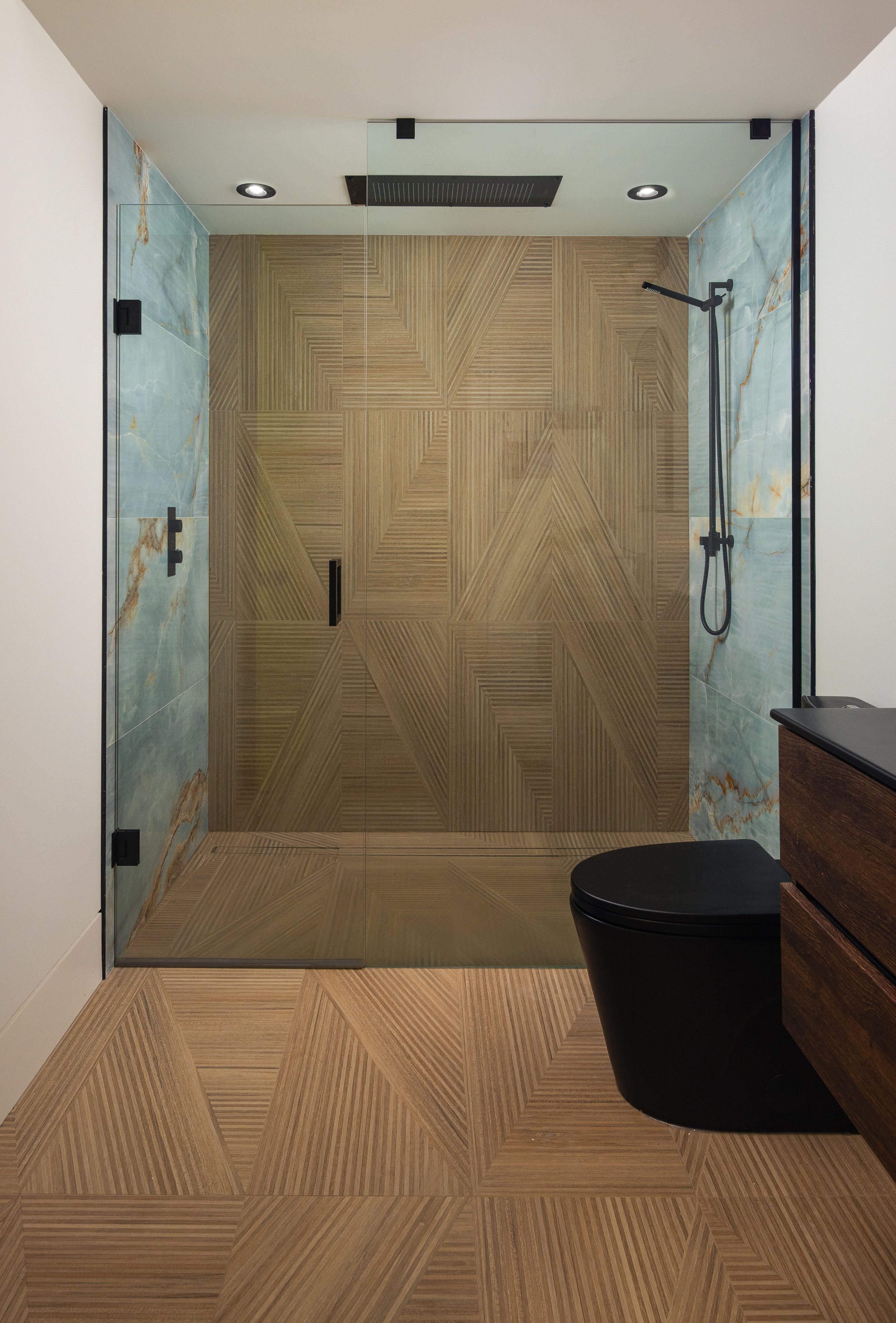 Modern bathroom with glass-enclosed shower and black toilet 