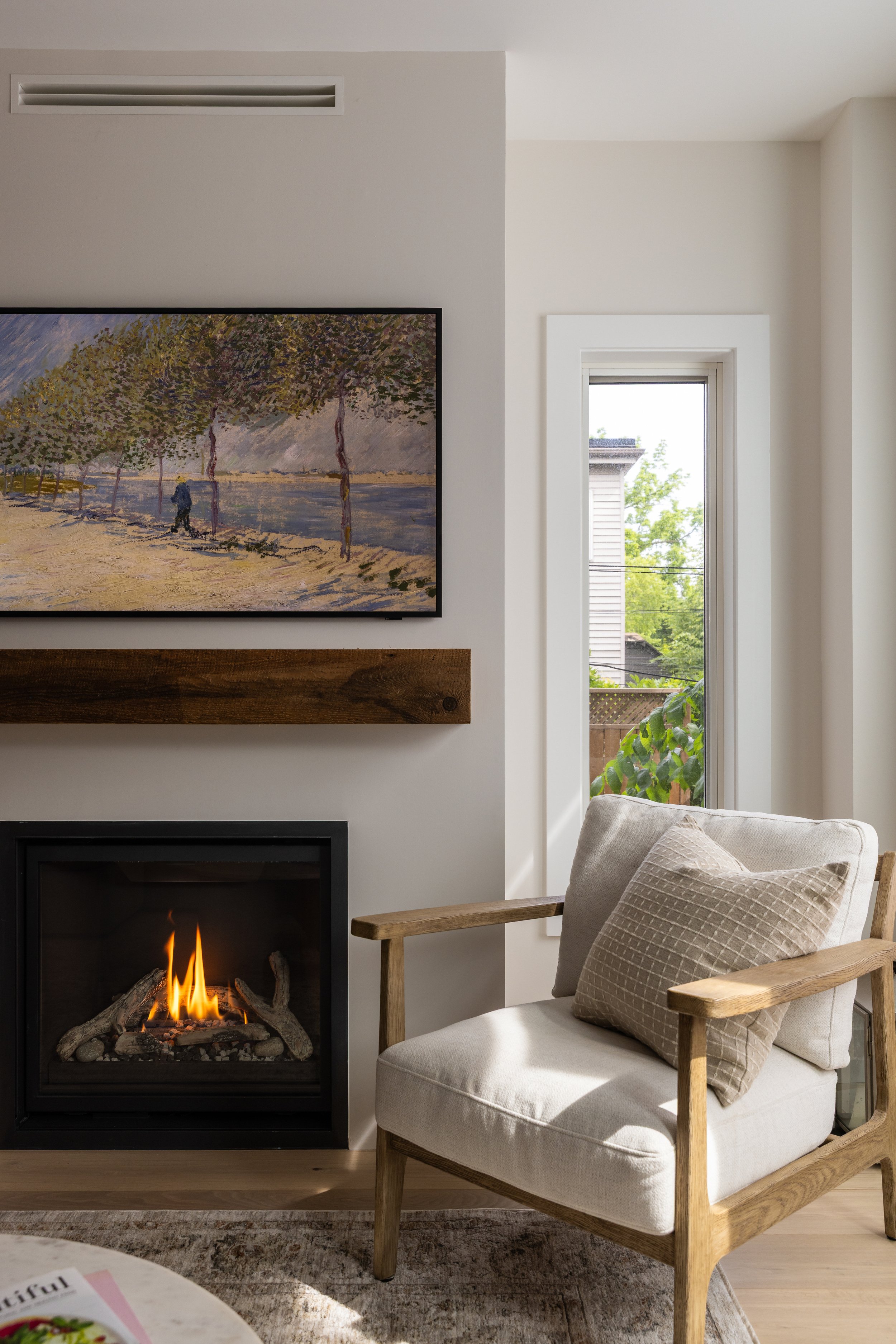 cozy living room corner featuring a gas fireplace with a comfortable modern chair