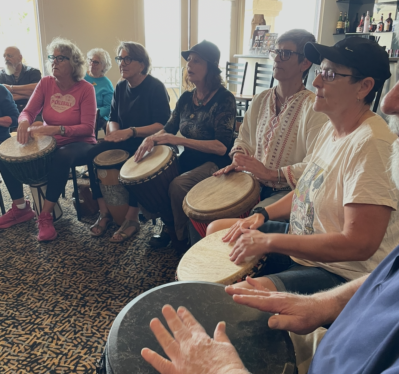 Community members participate in a drumming workshop with Okaijda Afroso (2025)