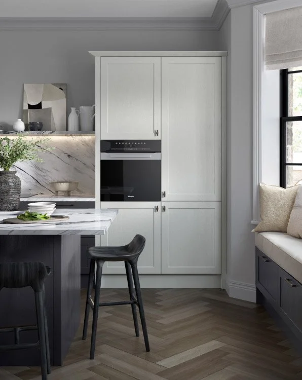 A beautiful modern style fitted kitchen with light shaker doors and stone worktops