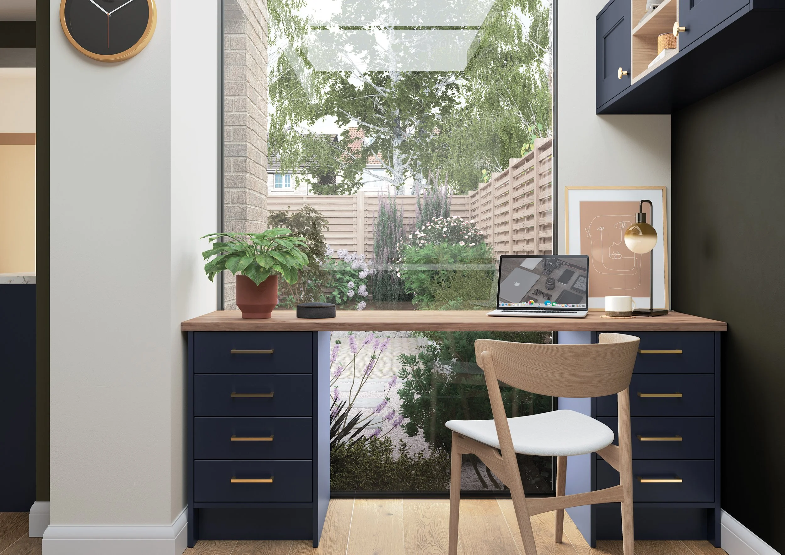 A modern and contemporary fitted home office with a matte navy finish with modern gold handles and a light ash wood worktop