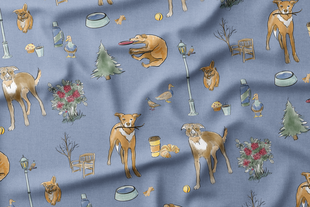 Illustrated pattern on blue background featuring dogs, ducks, trees, benches, street lamps, flowers, coffee cups, muffins, croissants, water bowls, and frisbees.