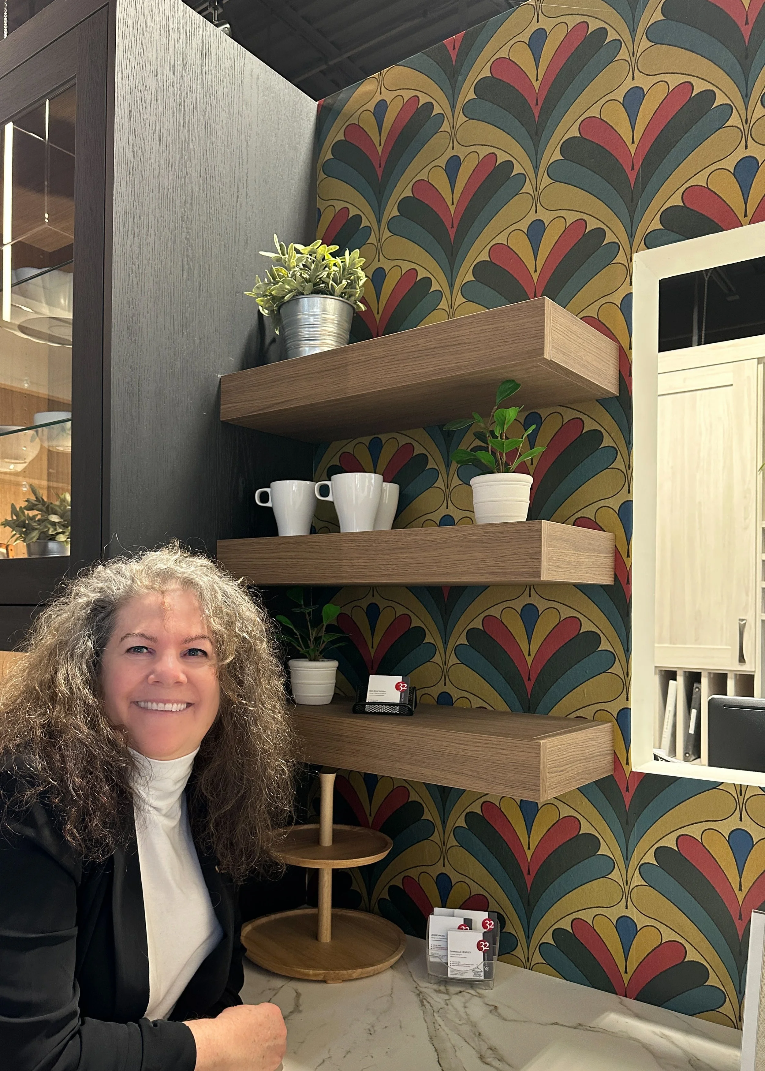 Gabrielle Hewson in front of her Art Deco Fans 04 installed in Concept 32's showroom Entry Drop-in