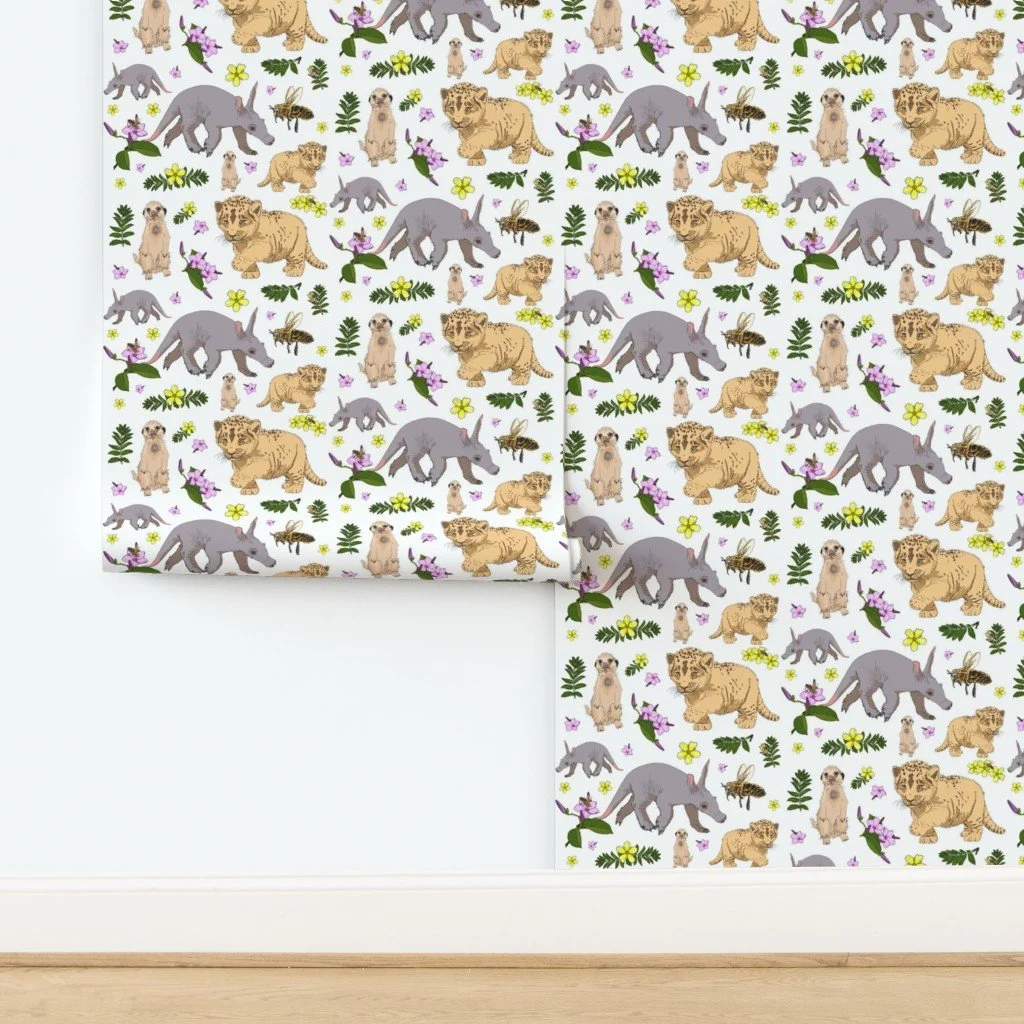 Illustration featuring a baby aardvark, lion cubs, meerkat, bee, and various flowers and leaves on a white background.