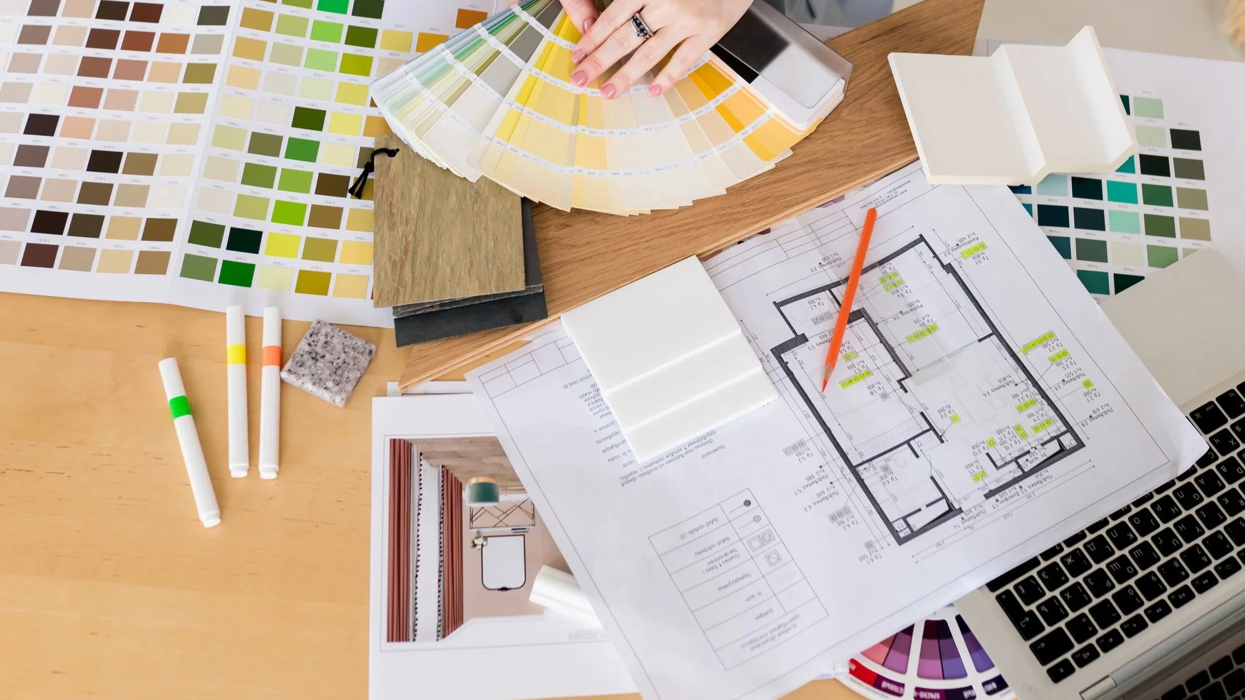 Living room mid-install with furniture, samples, and tools visible, showing a decorating project in progress.