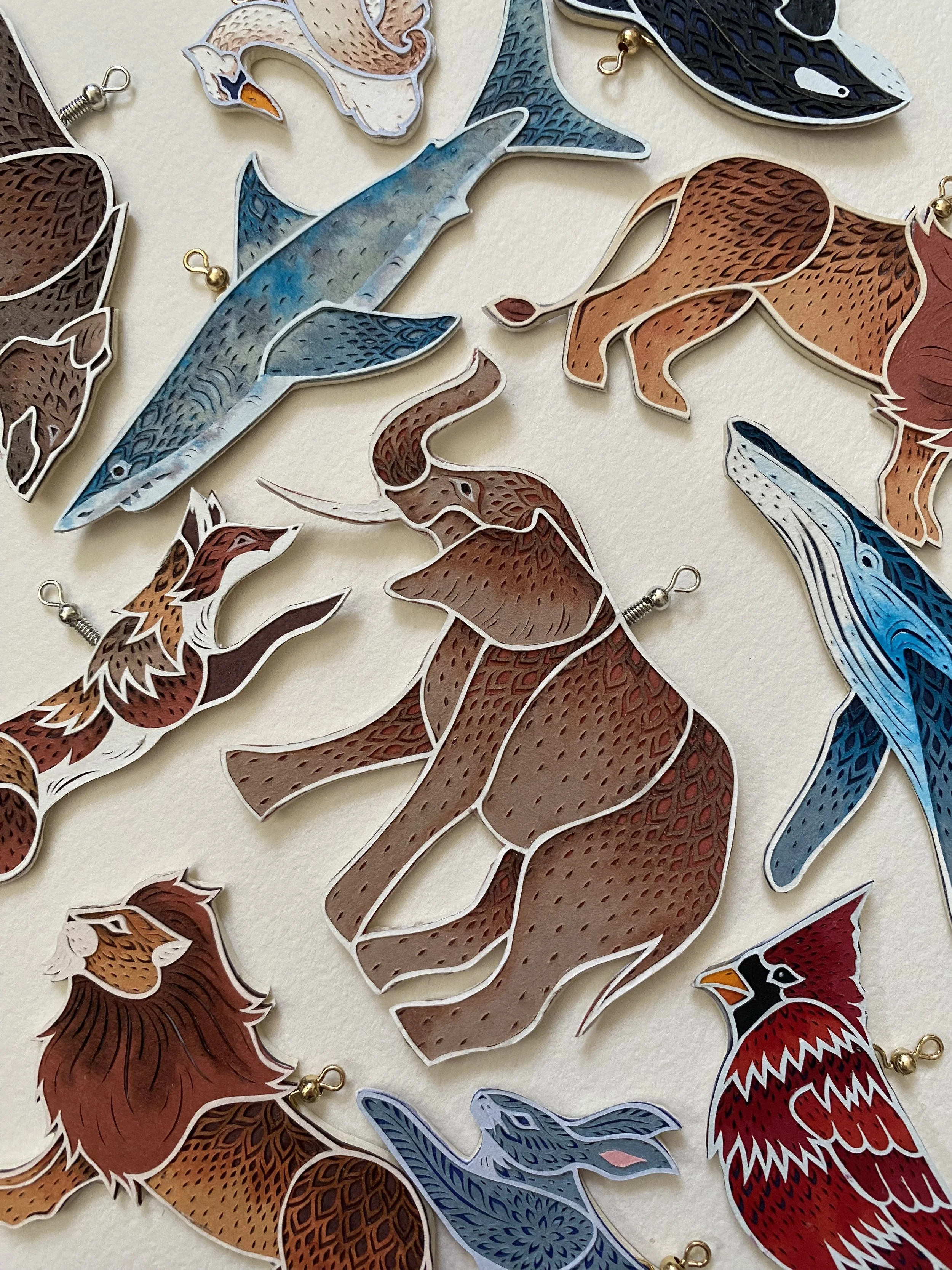 Selection of hand cut paper ornaments. 2025 Holiday Collection