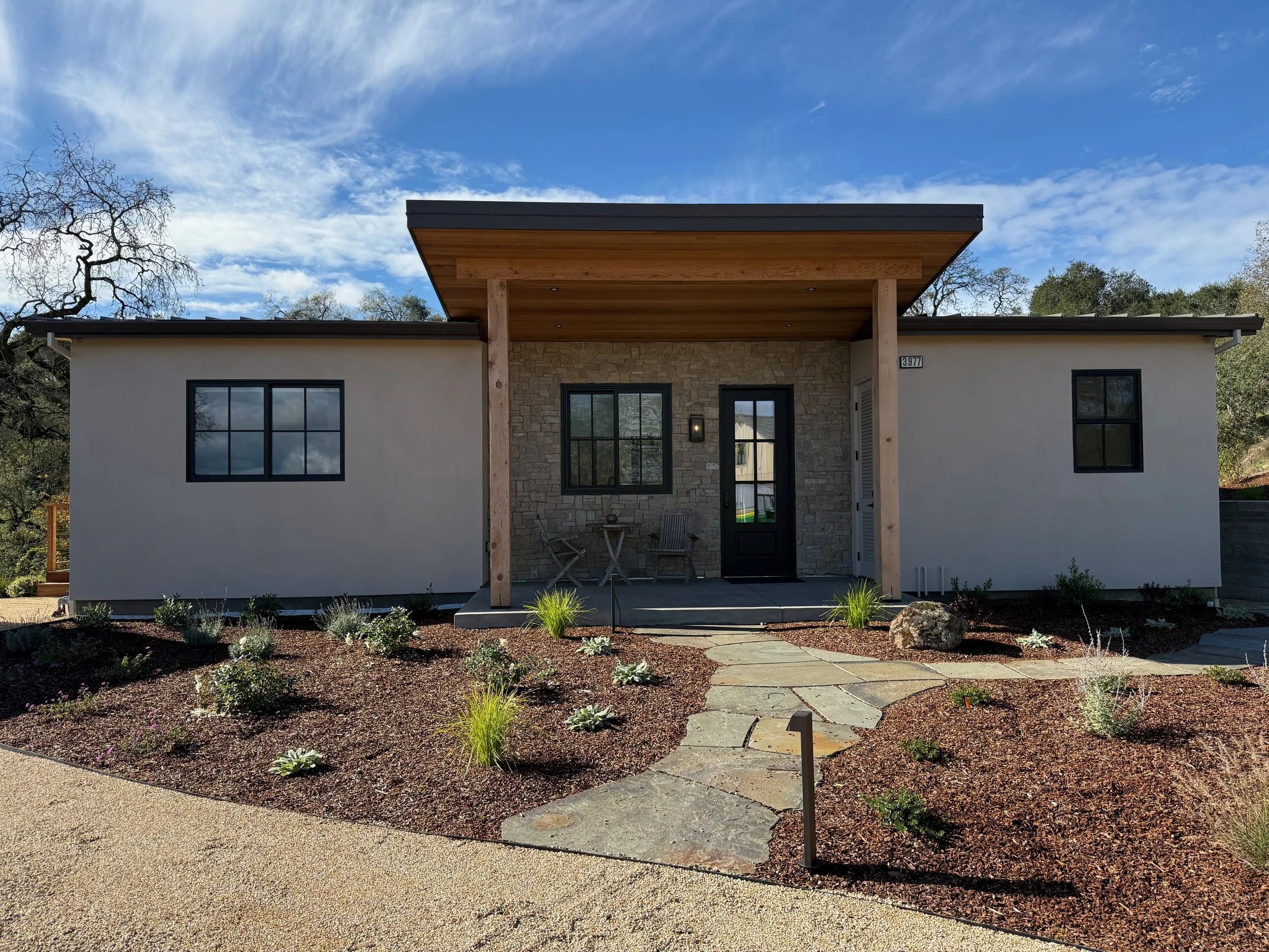 Front yard of ADU with flagstone pathway to front porch and low voltage pathlights.