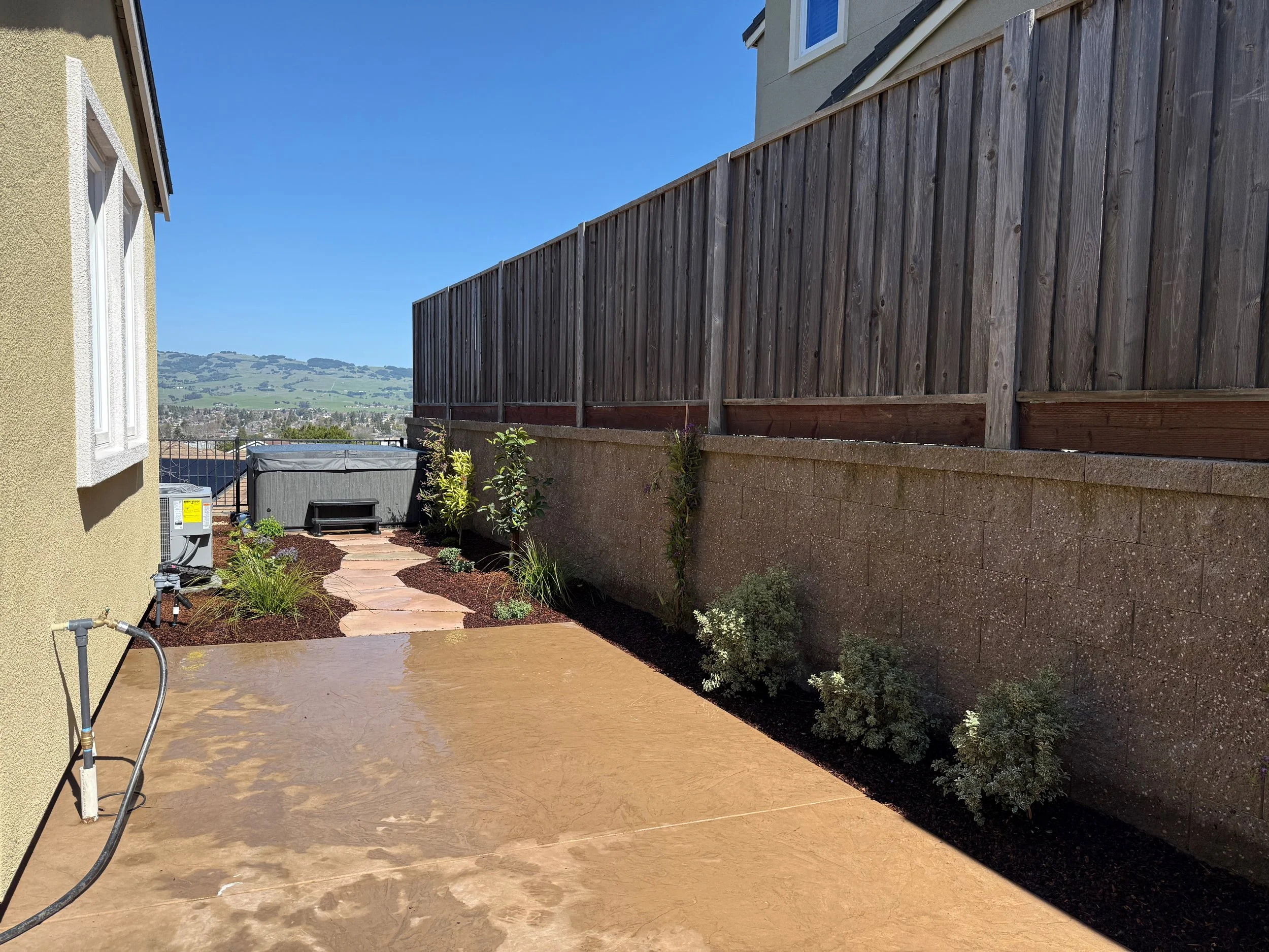 Stamped concrete patio and low maintenance garden in West Petaluma.