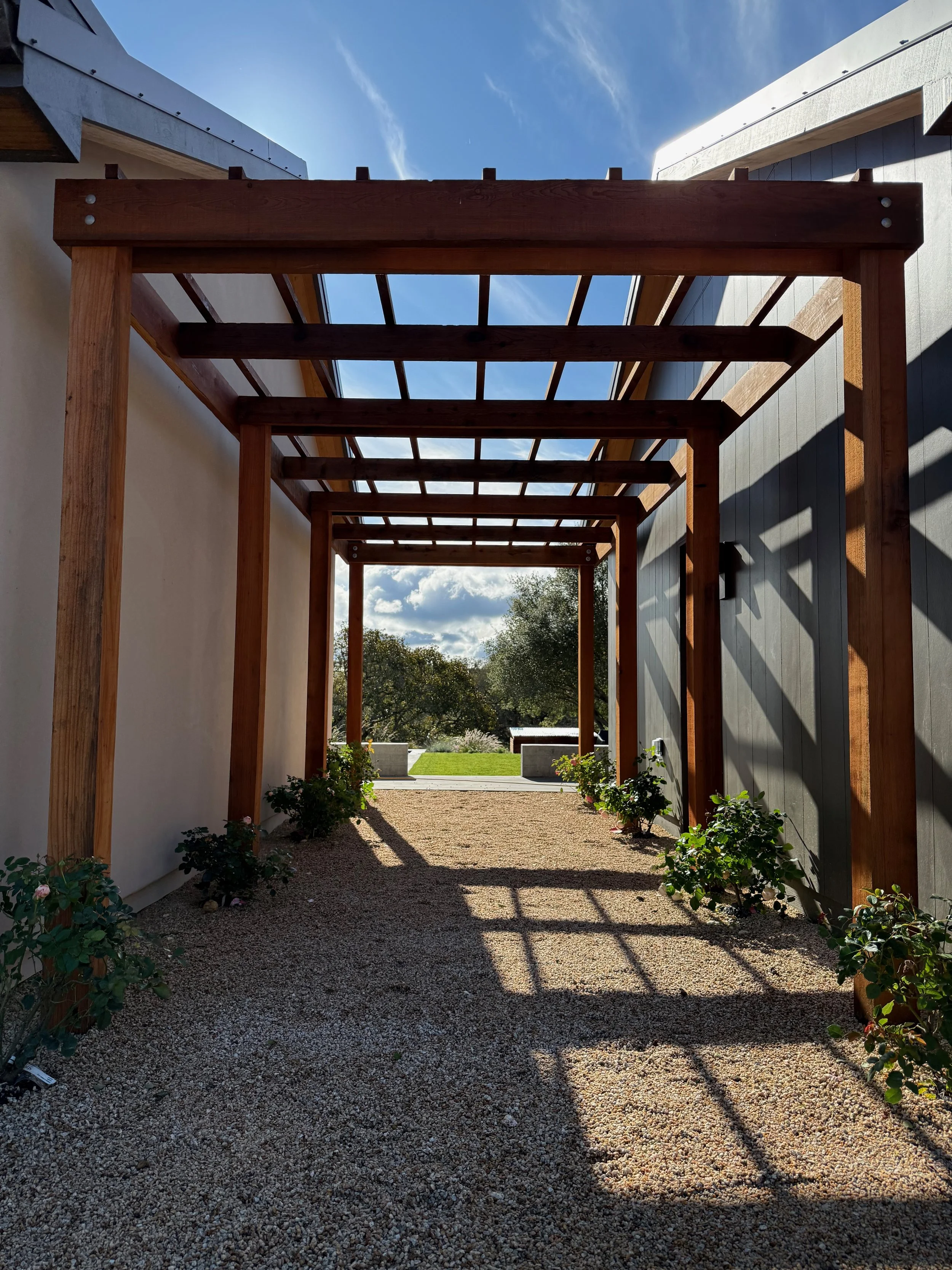 6 - posted redwood pergola takes you between main house and garage to modern backyard and pool.