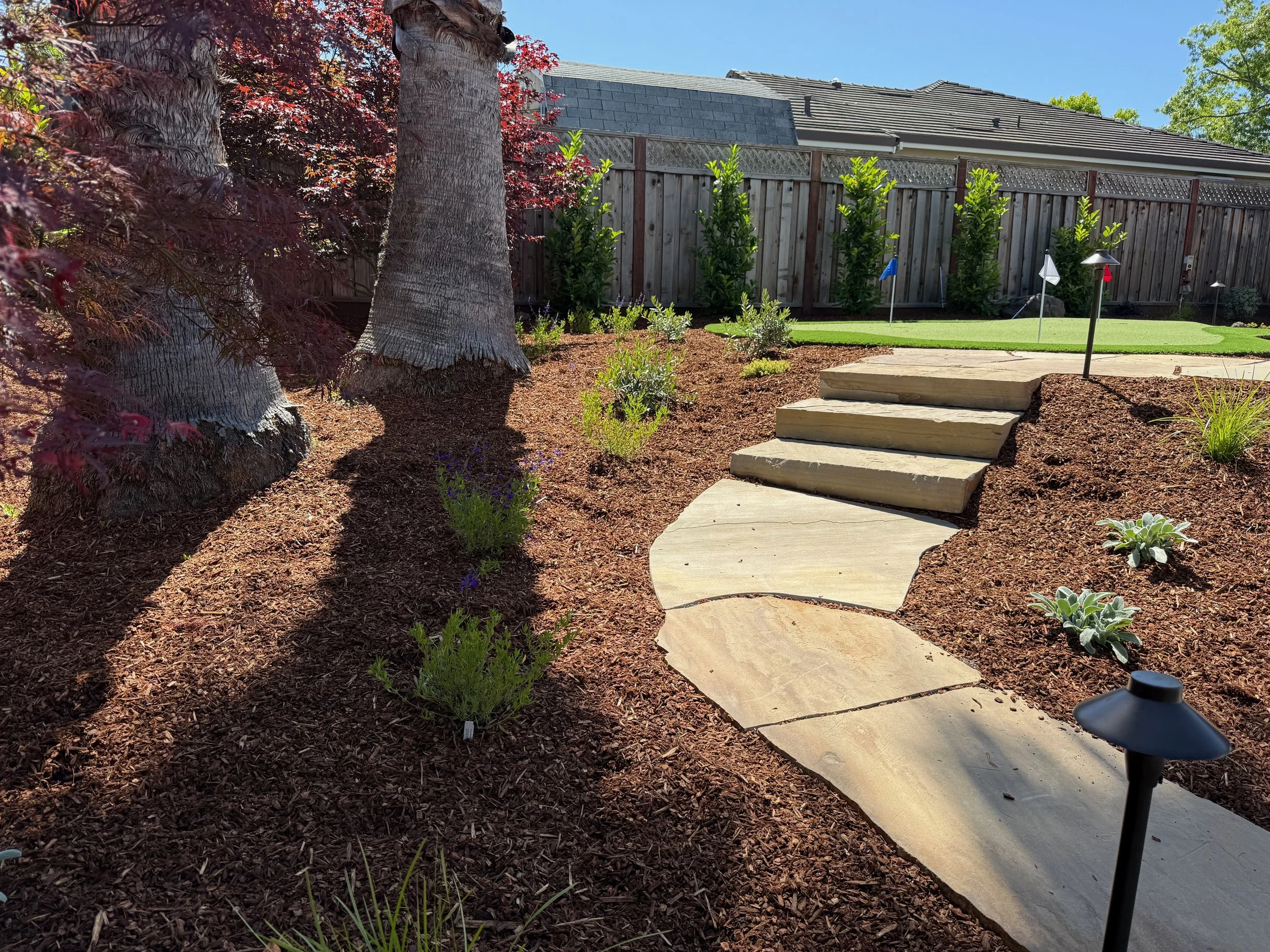 Flagstone walkway and dakota steps with putting green and low voltage lighting in Petaluma, CA.
