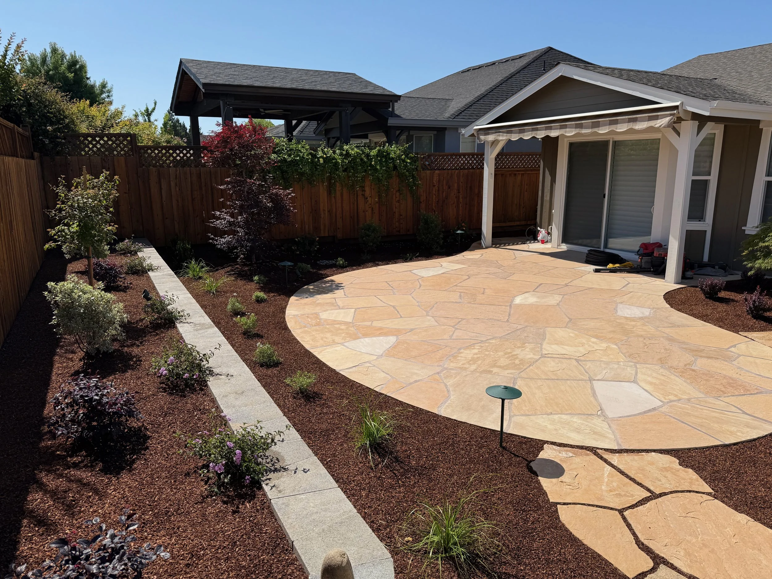 Flagstone patio and surrounding landscaping in Santa Rosa, CA.