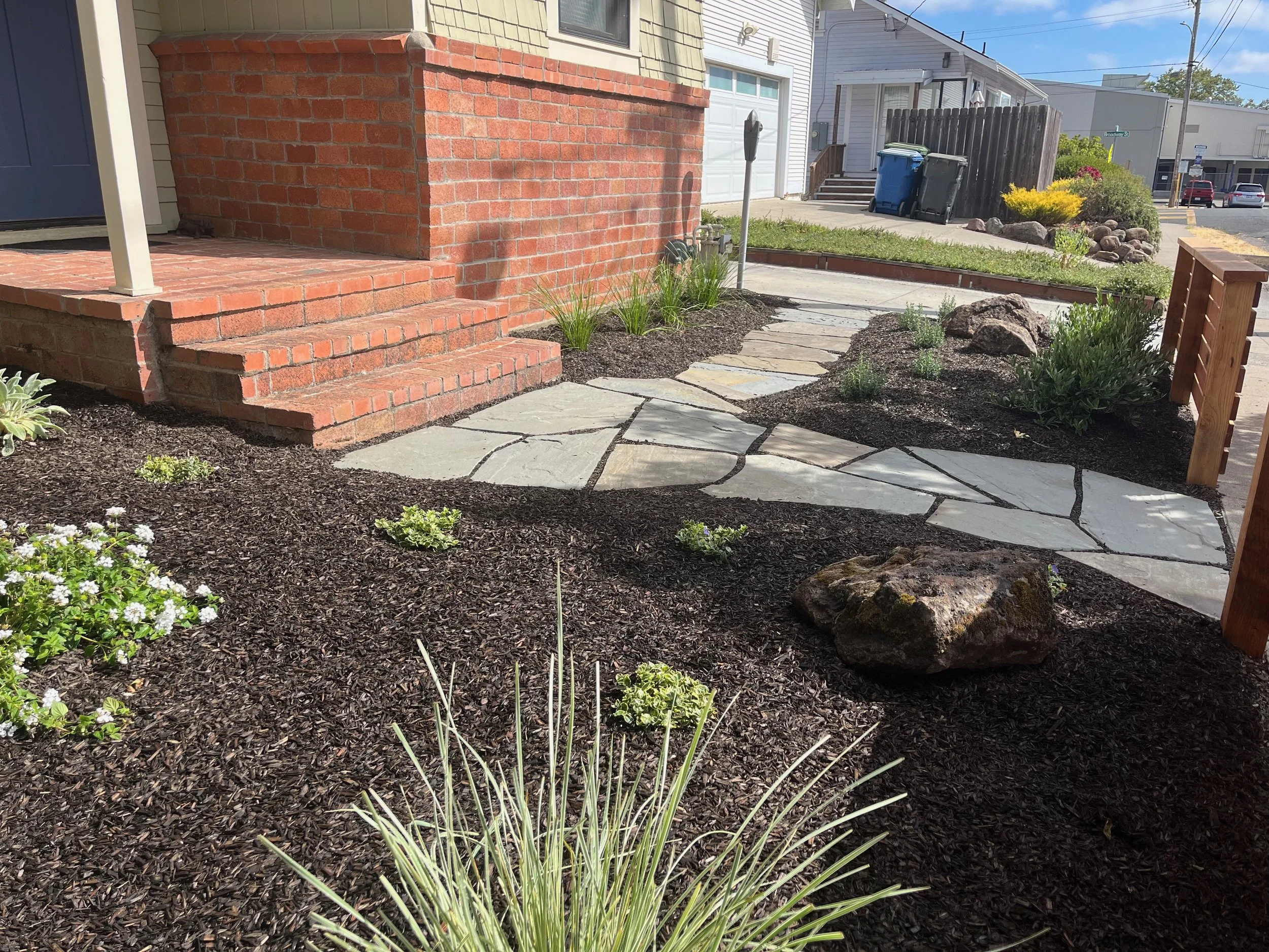 Front yard landscaping with flagstone walkways and low maintenance plants.