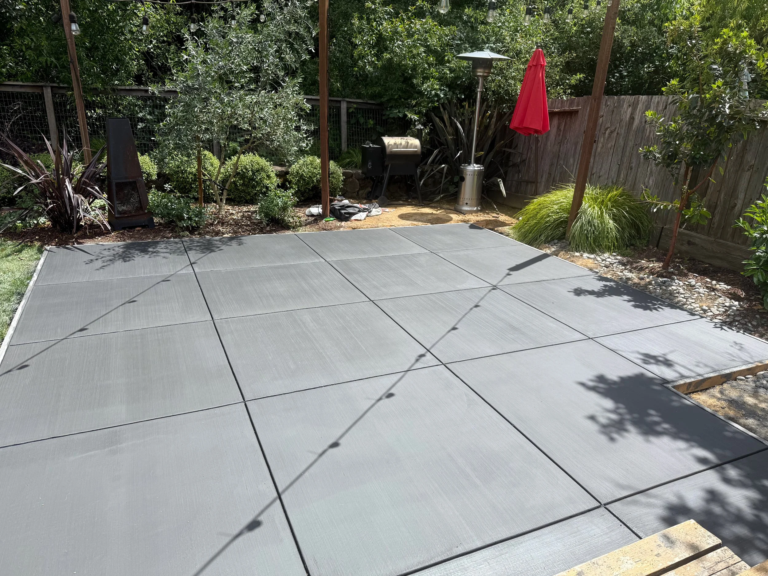 Grey colored concrete patio with grid score marks.