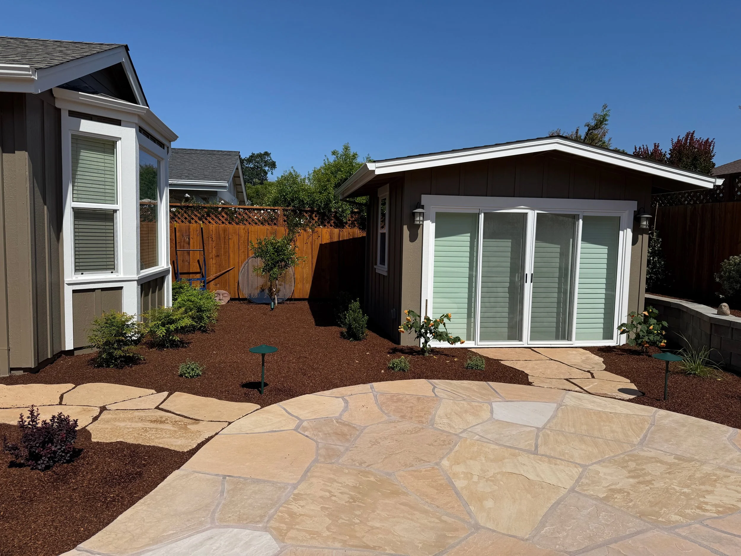 Multi-colored Arizona flagstone patio and walkway with surrounding plantings in Santa Rosa, CA.
