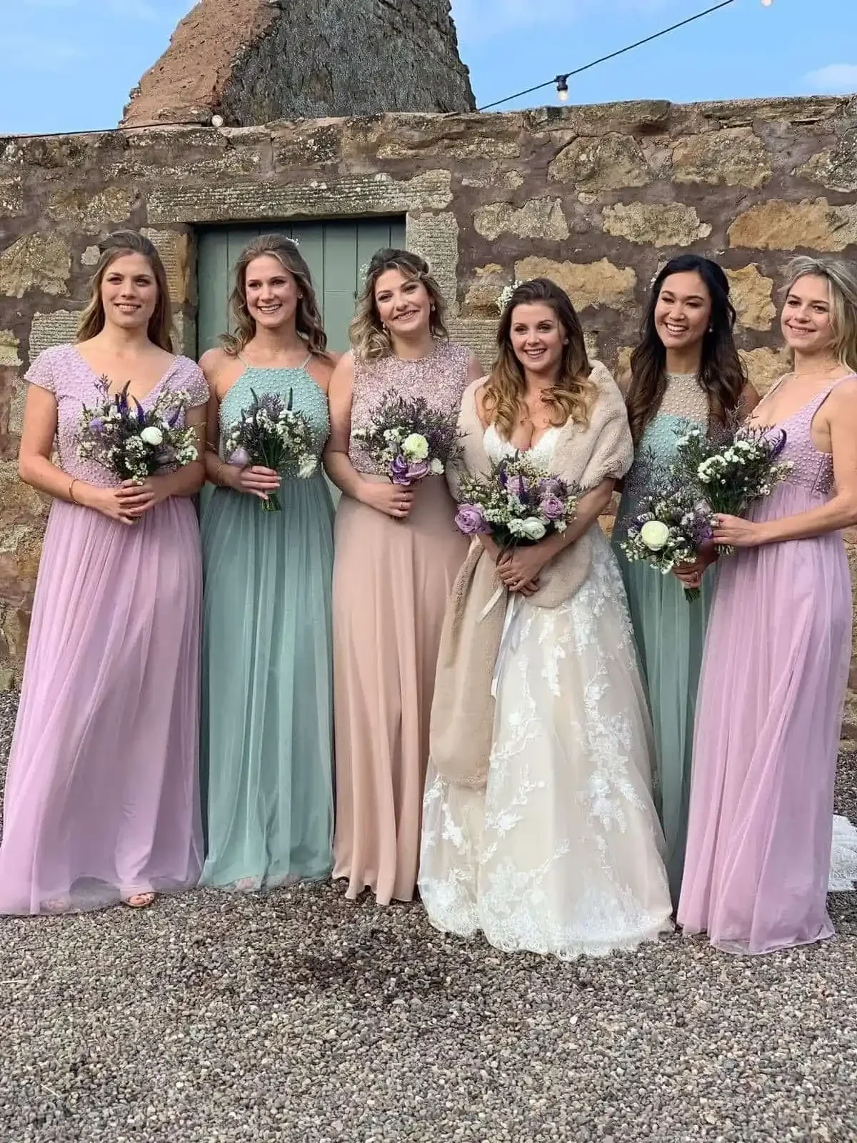 Wedding Makeup for your Bridemaids - Bride with her Bridesmaids holding floral bouquets