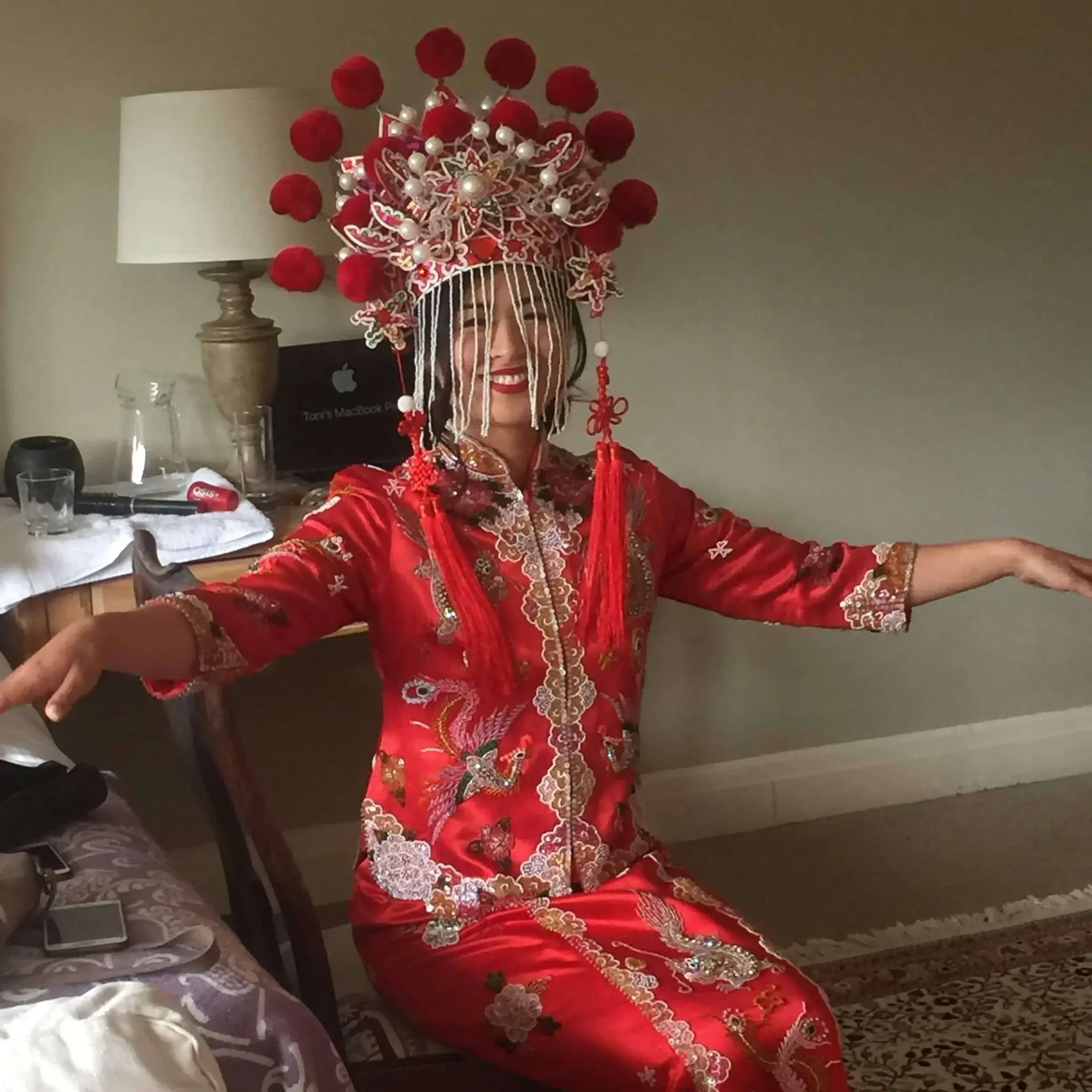 Chinese bride in fabulous headdress getting ready for the tea ceremony