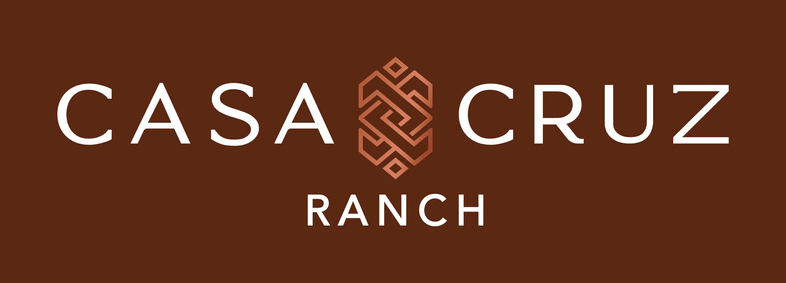 Logo for Casa Cruz Ranch featuring a geometric design in the center, with the words "Casa Cruz" above and "Ranch" below on a brown background.