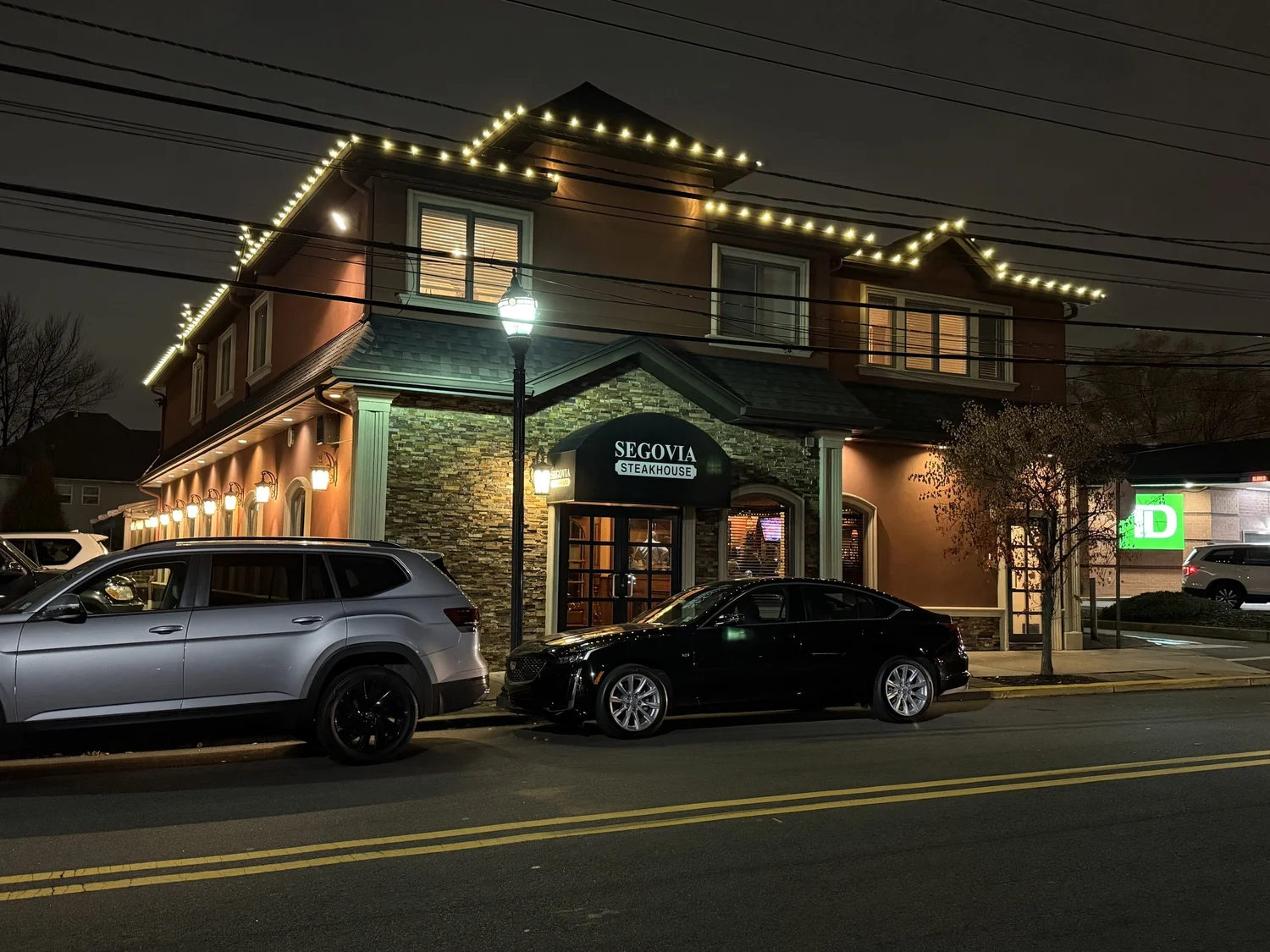 Restaurant exterior illuminated with holiday roofline lights