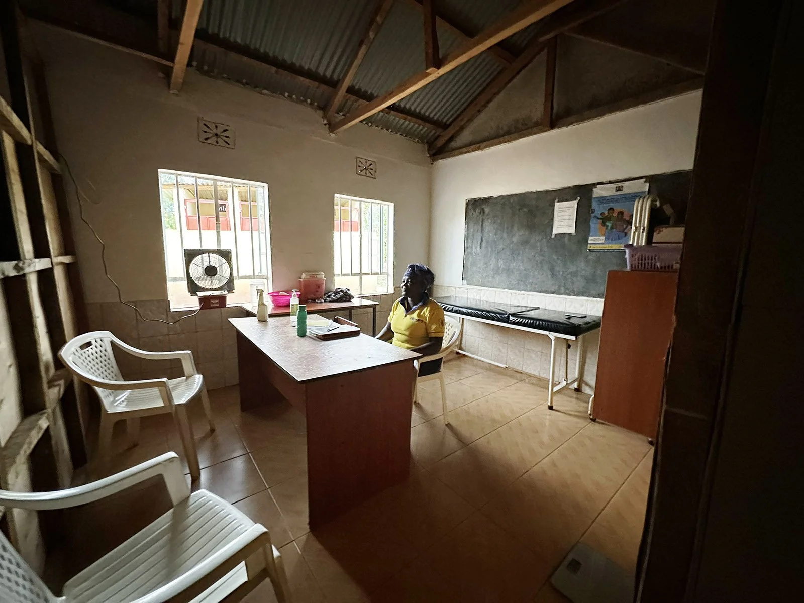 A woman sitting at a desk in the health clinic