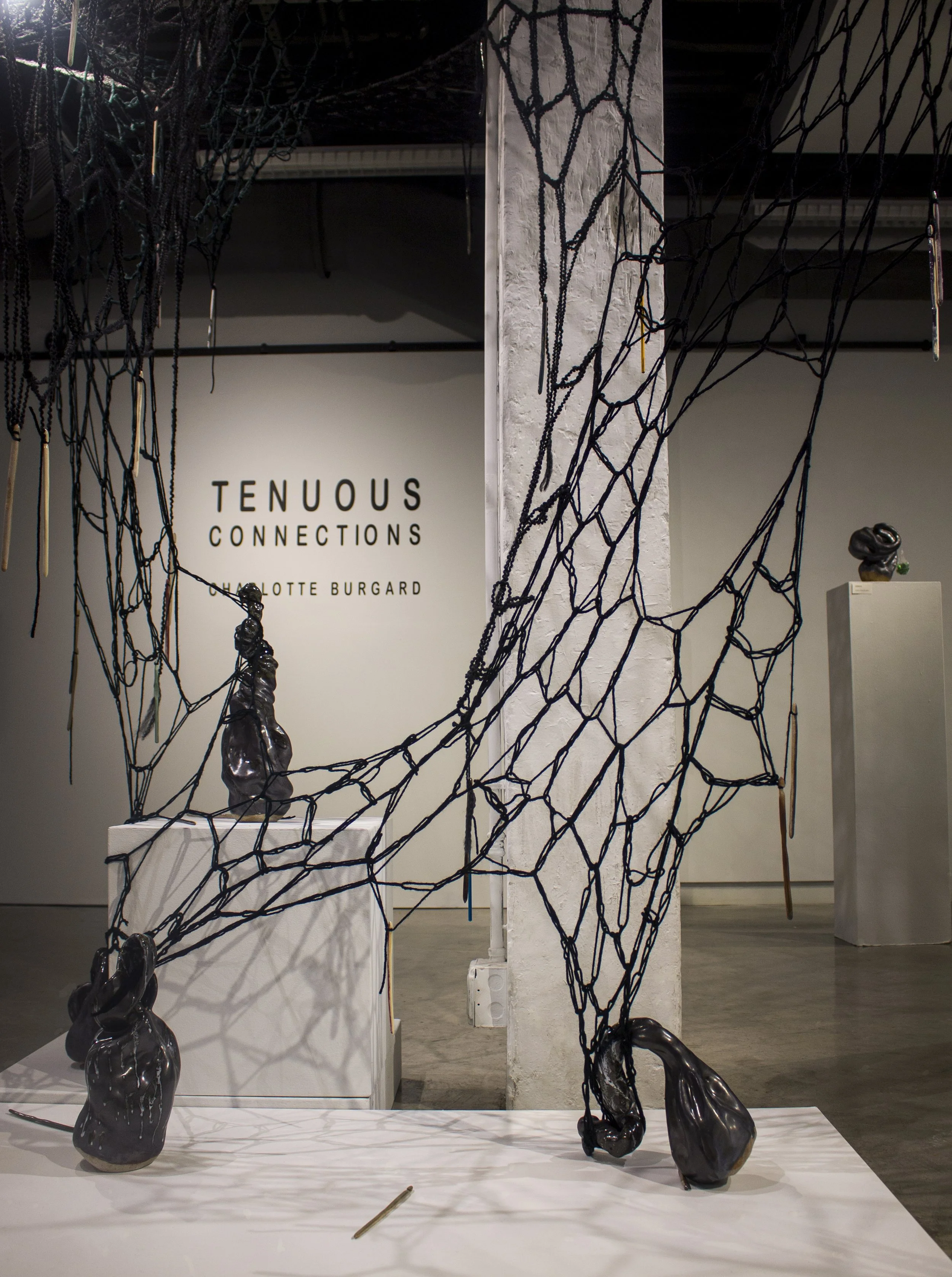 Ripples of Craft: A Symphony in Woven Threads and Ceramic Chimes, 2023, 8.5ft (tall) x 5ft (wide) x 4.5ft. Black wool and acrylic yarn, ceramic crochet hooks, and metal crochet hooks gifted from grandma and great grandma.

Ripple of Craft is a detail