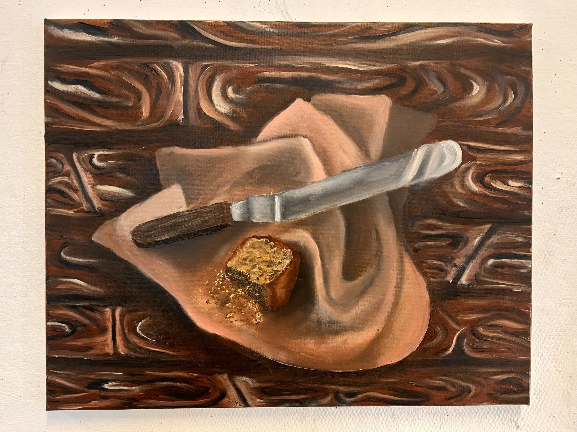 "Remnants of a Picnic" // Oil paint on canvas // 16" X 20" // 2022 // A stale piece of cake lying next to a palette knife. The cake decays, becoming inedible, while the knife is used to create a new, fresh confection.