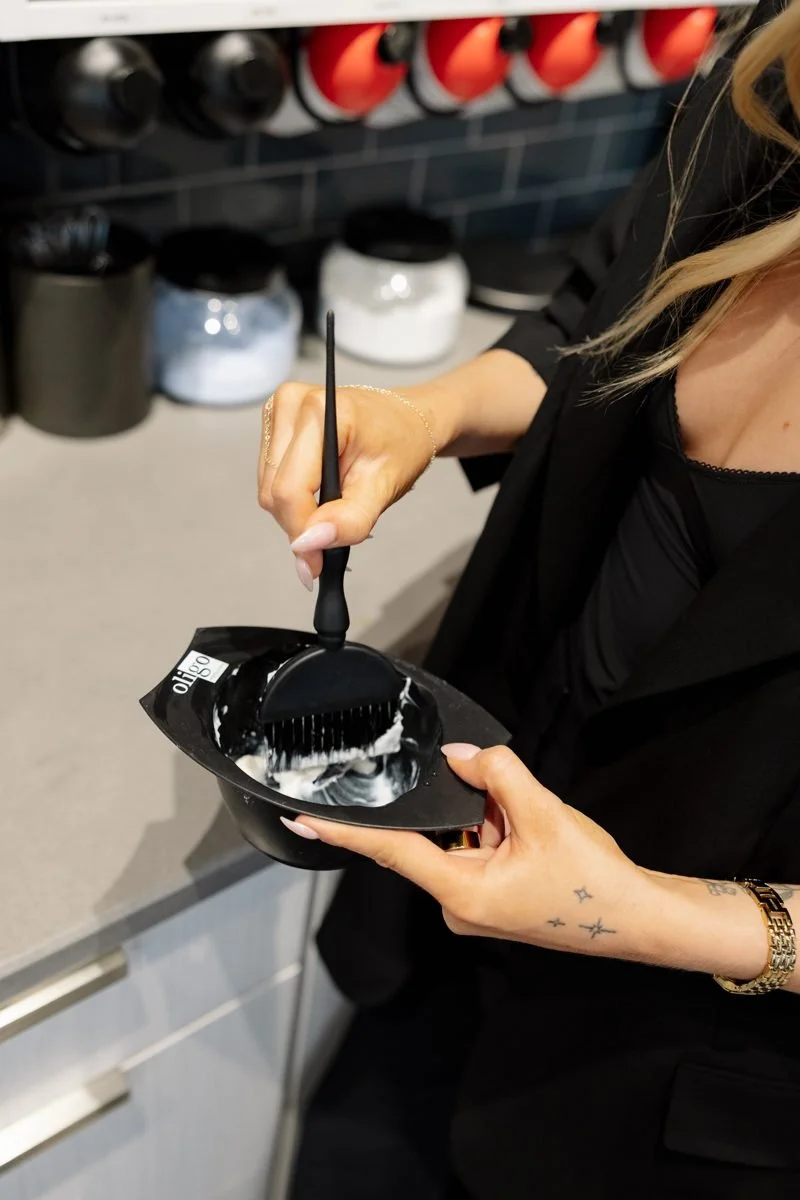 Mixing Oligo lightener for a blonde service at Grand Noir Salon in Verona, WI