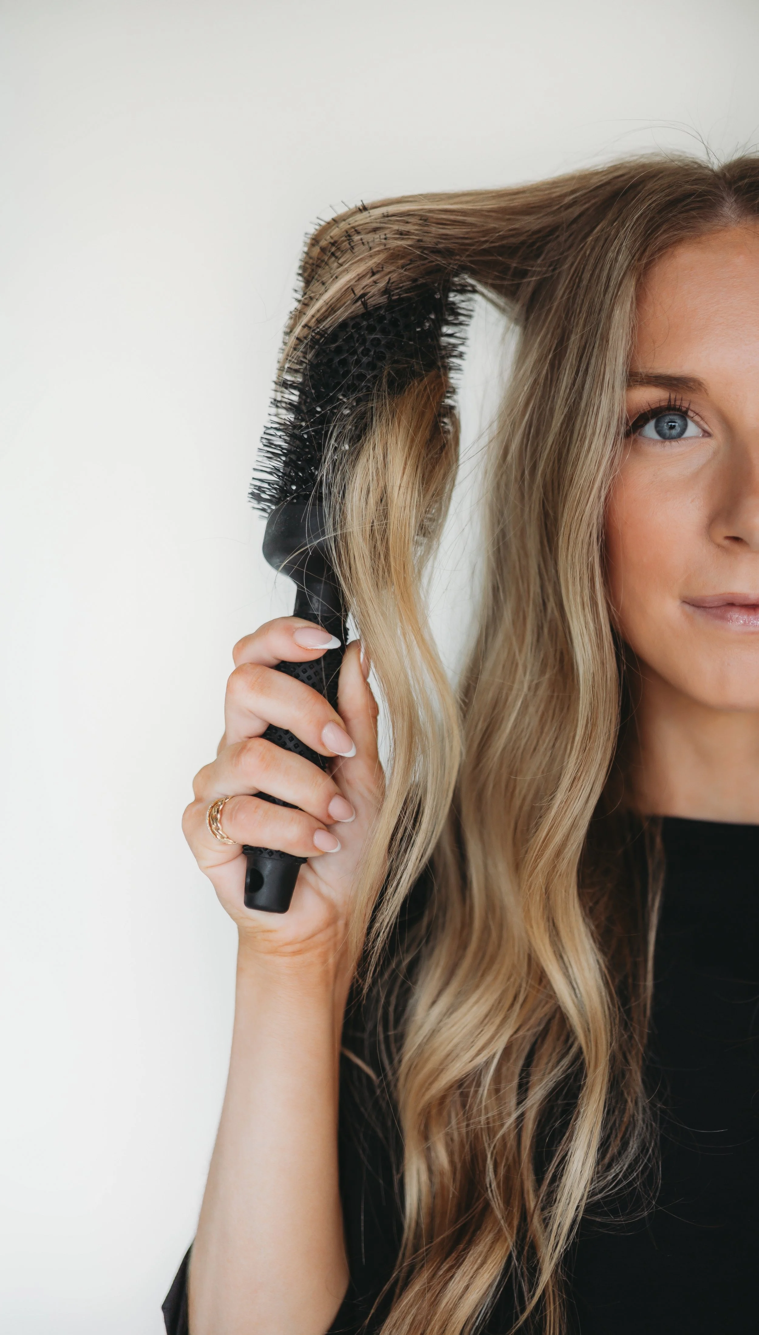 Round brush blowout on blonde balayage at Grand Noir Salon in Verona, WI
