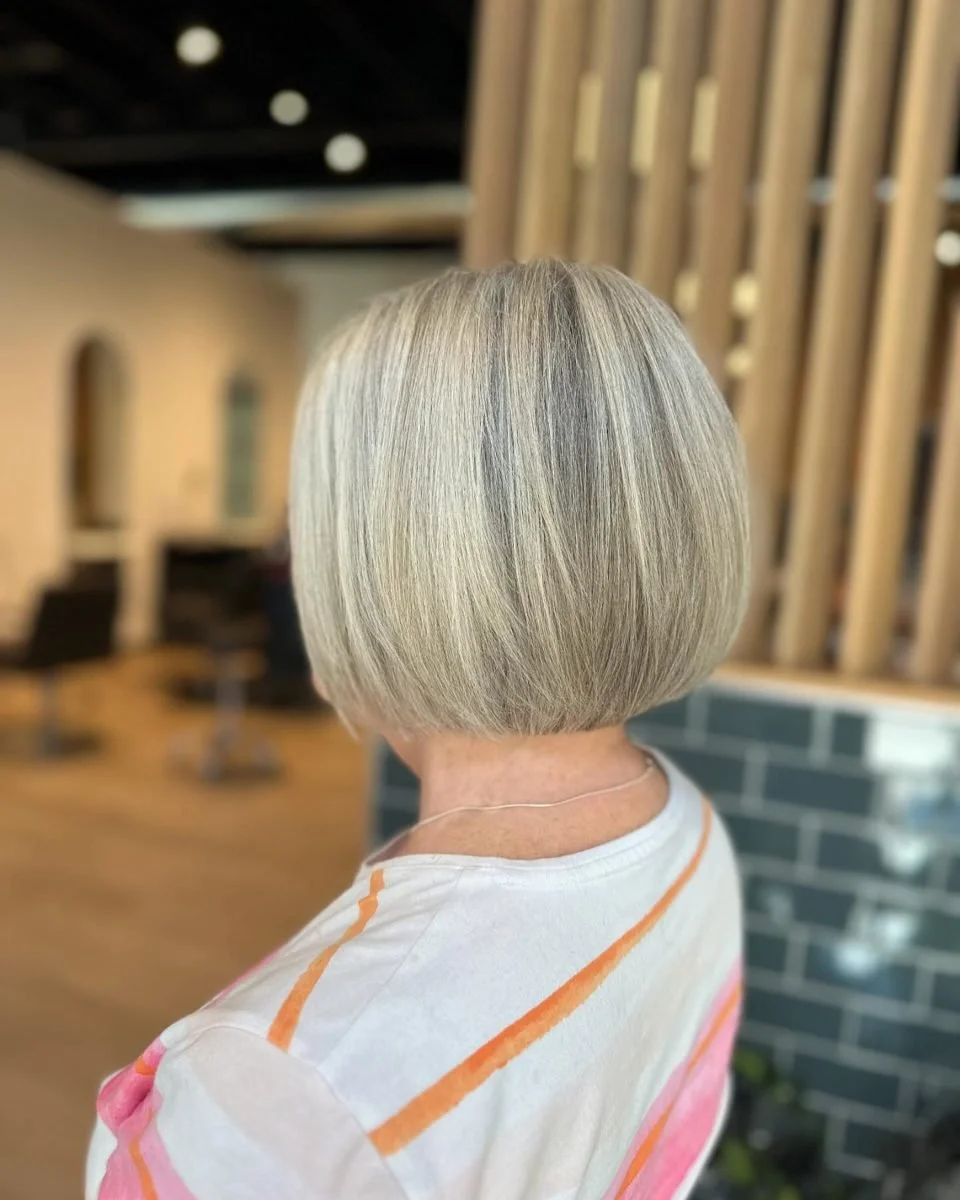 Blended grey highlights on a classic bob haircut at Grand Noir Salon in Verona, WI